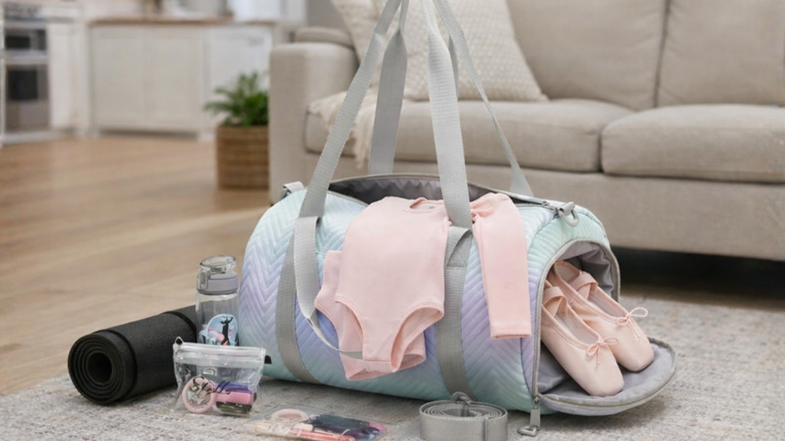A duffle bag with dance leotard, ballet shoes, and hair accessories.