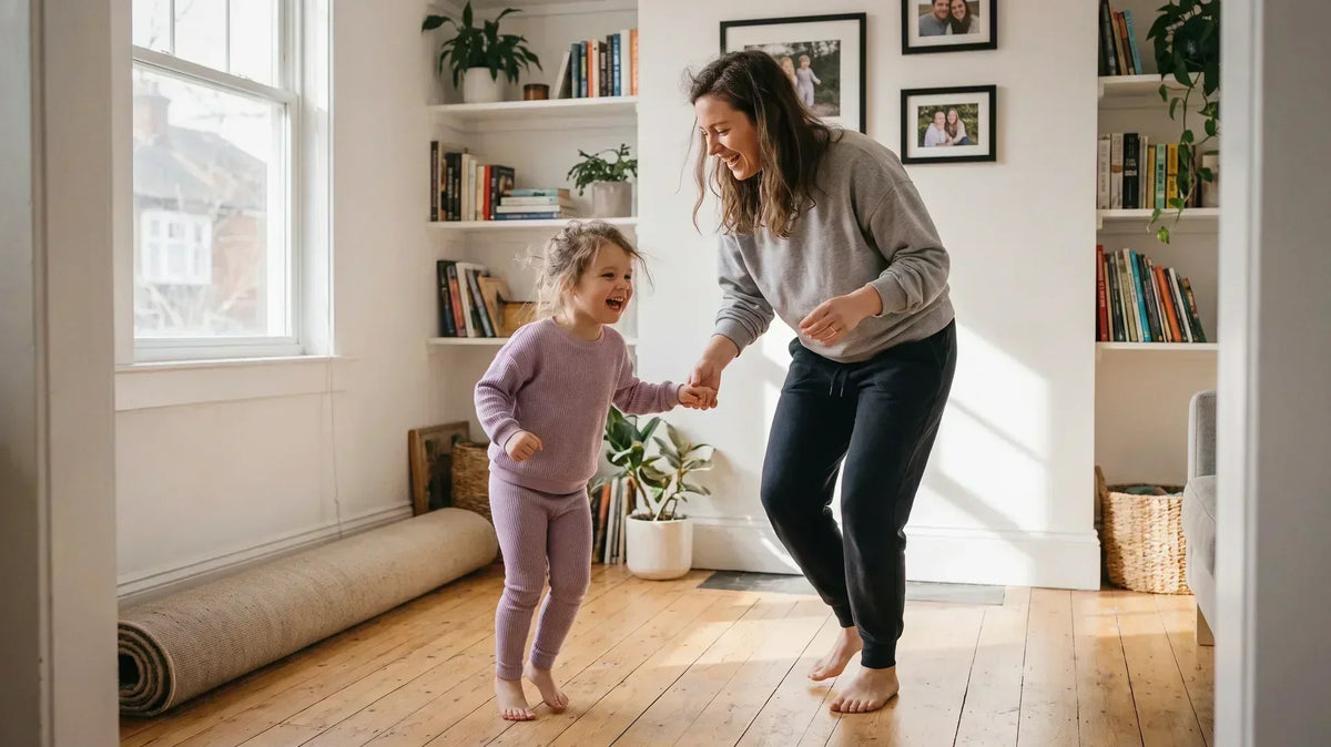 Parent and child learning how to dance together at home