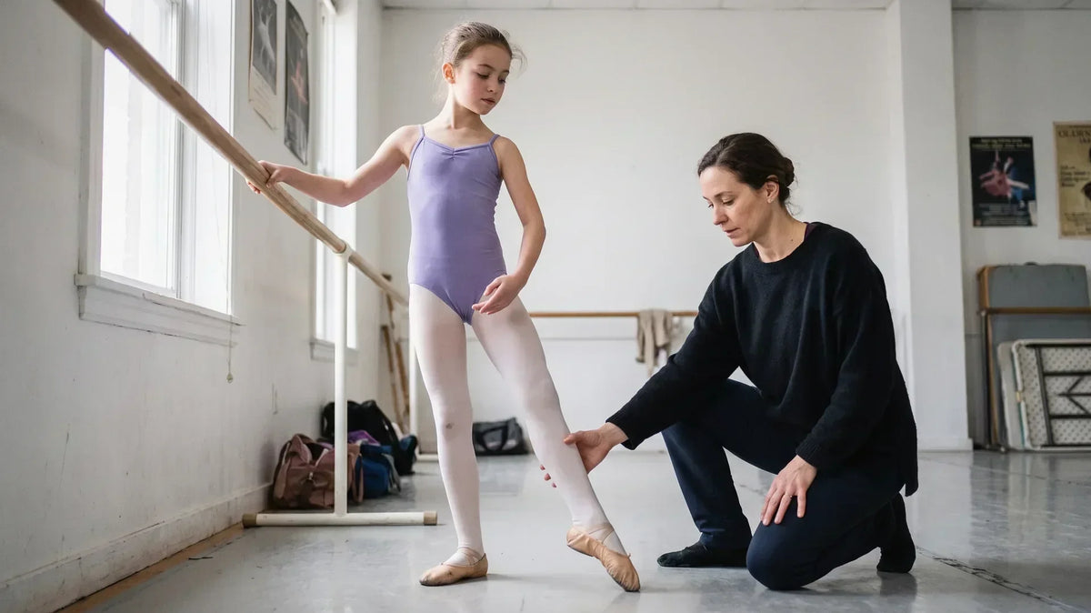 Young ballet dancer pointing her foot at the barre, showing the sickled feet dance teachers correct in class