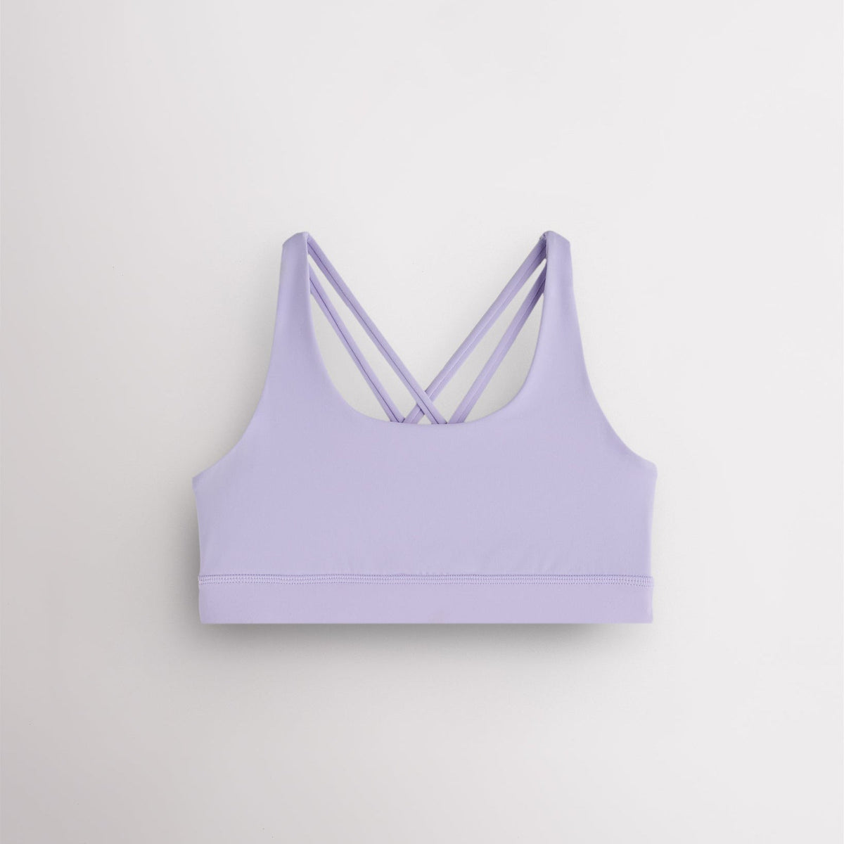 Girls lavender sports bra with a scoop neckline, supportive band, and strappy criss-cross back design.