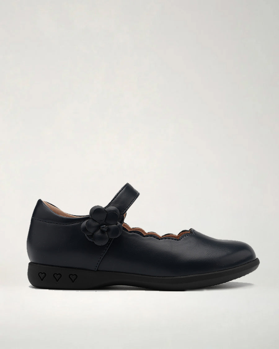 A black Mary Jane style flat shoe with a bow on the strap and a scalloped edge on the upper.