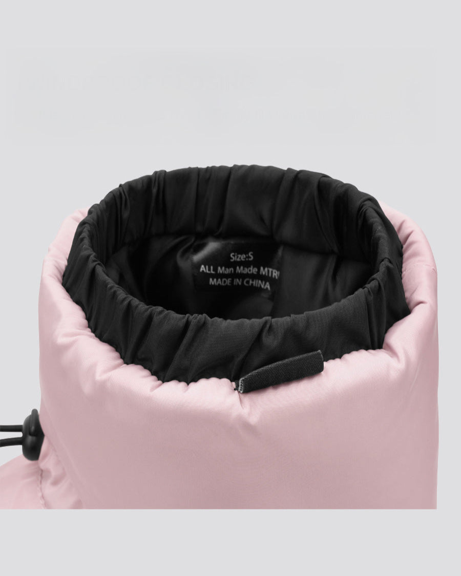 Close-up of a pink jacket with black interior lining on a light gray background