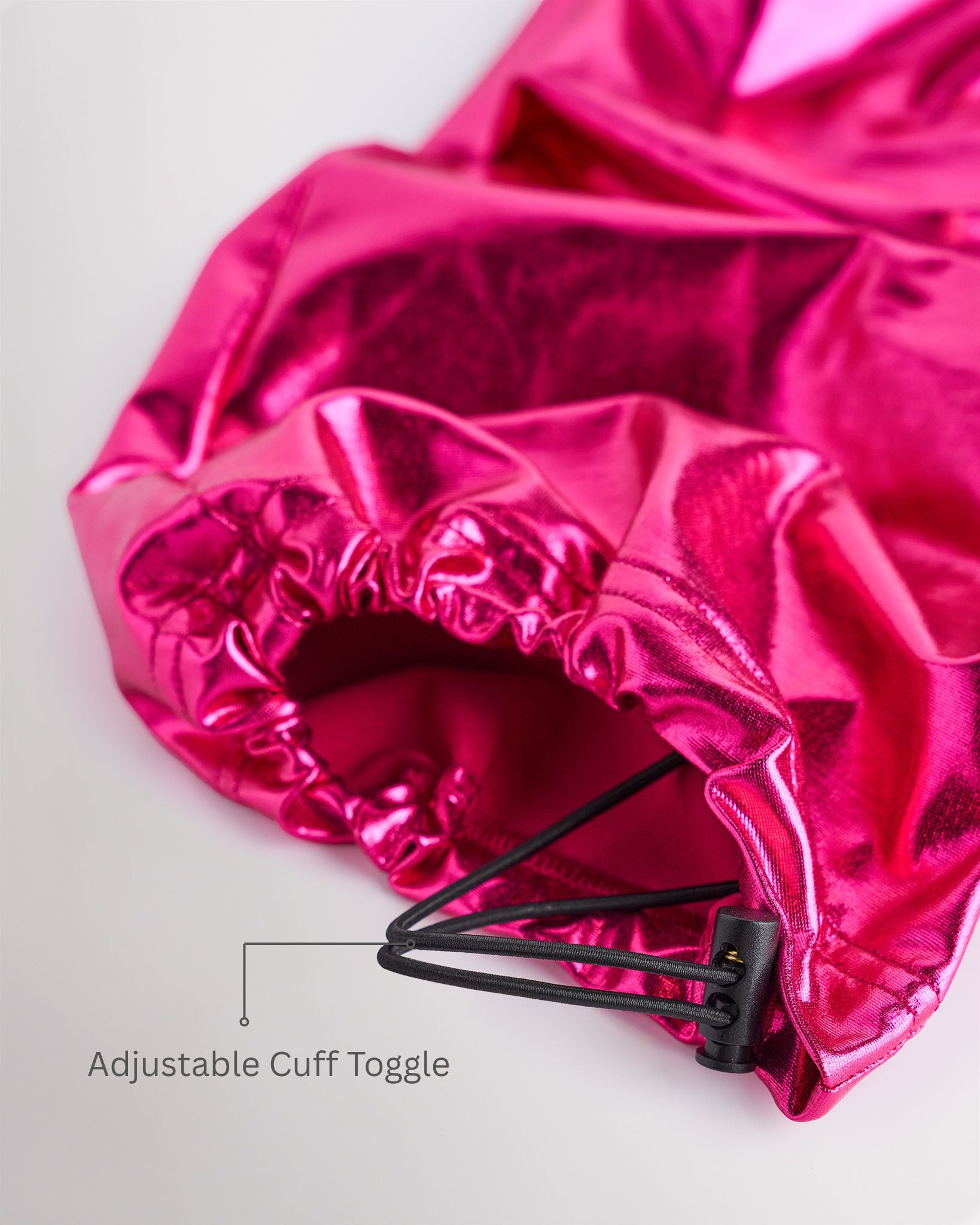 Close-up of metal fuchsia girls cargo pants showing the adjustable cuff toggle at the hem for switching between wide-leg and tapered jogger styling.