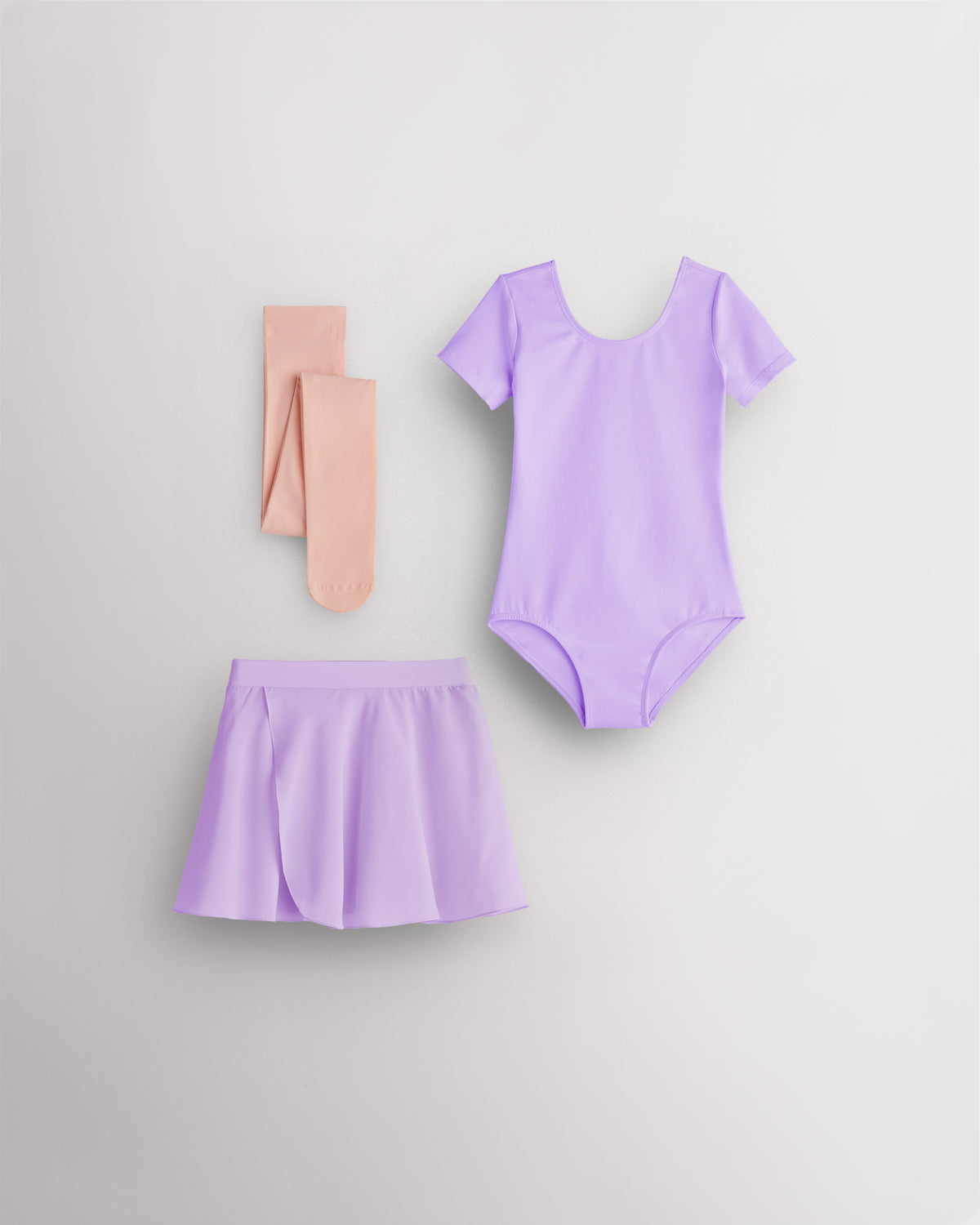 Lavender girls ballet starter kit laid flat with short sleeve leotard, red chiffon pull-on skirt, and ballet pink footed tights.