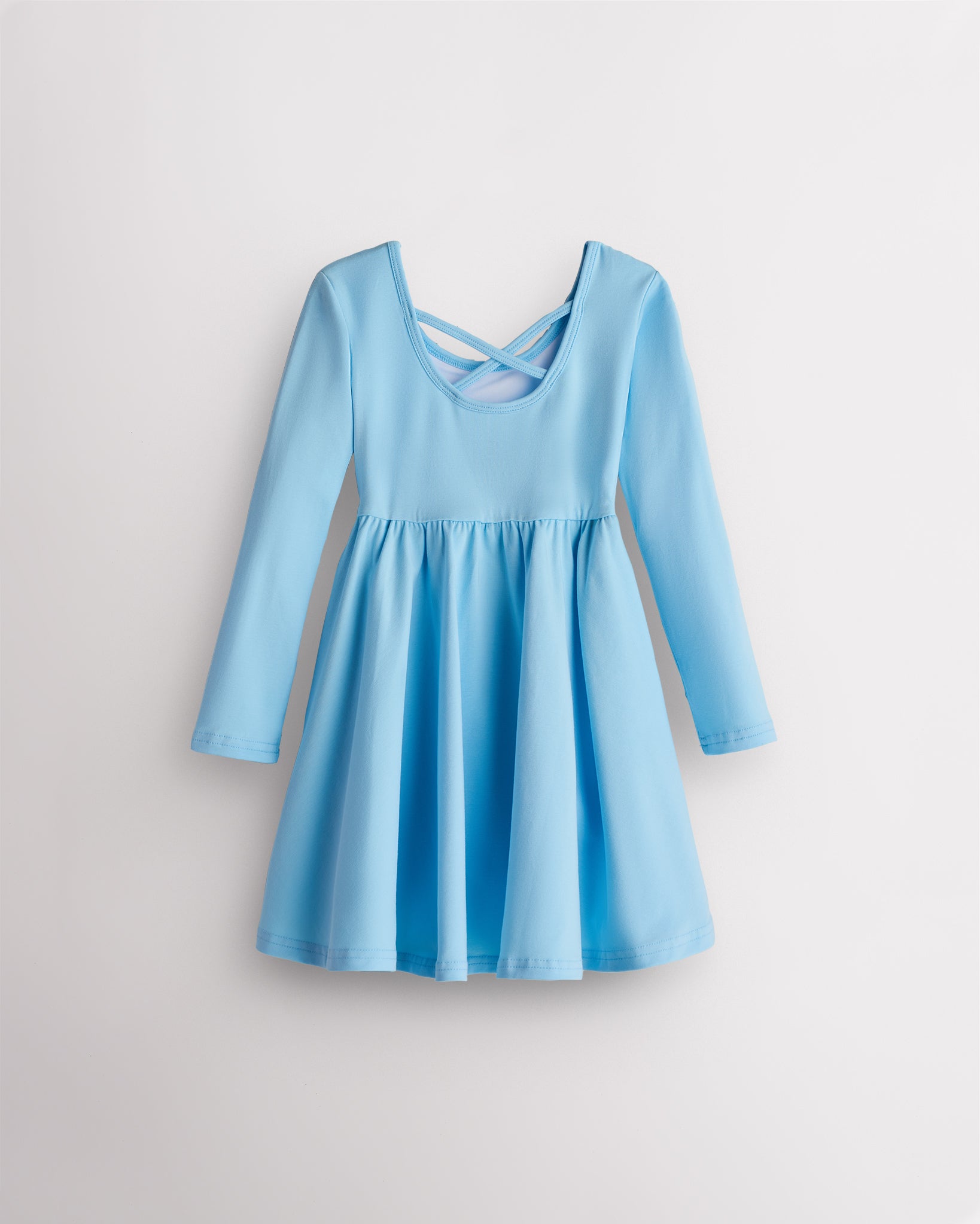 Back view of sky blue Stelle girls long sleeve twirly dress with crisscross strap detail and flared skirt