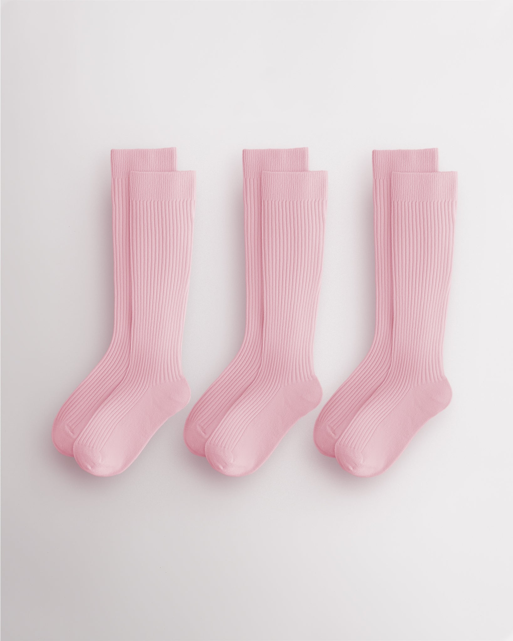 Three pairs of pink kids ribbed calf socks with supportive no-slip fit and seamless toe design for school and everyday wear.
