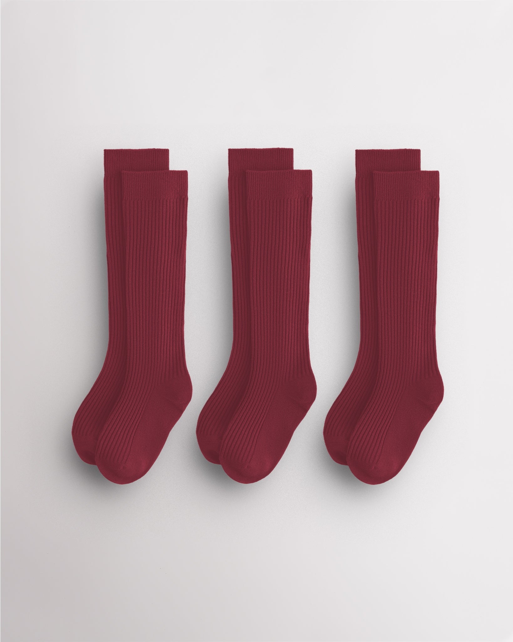 Three pairs of red kids ribbed calf socks with supportive no-slip fit and seamless toe design for school and everyday wear.