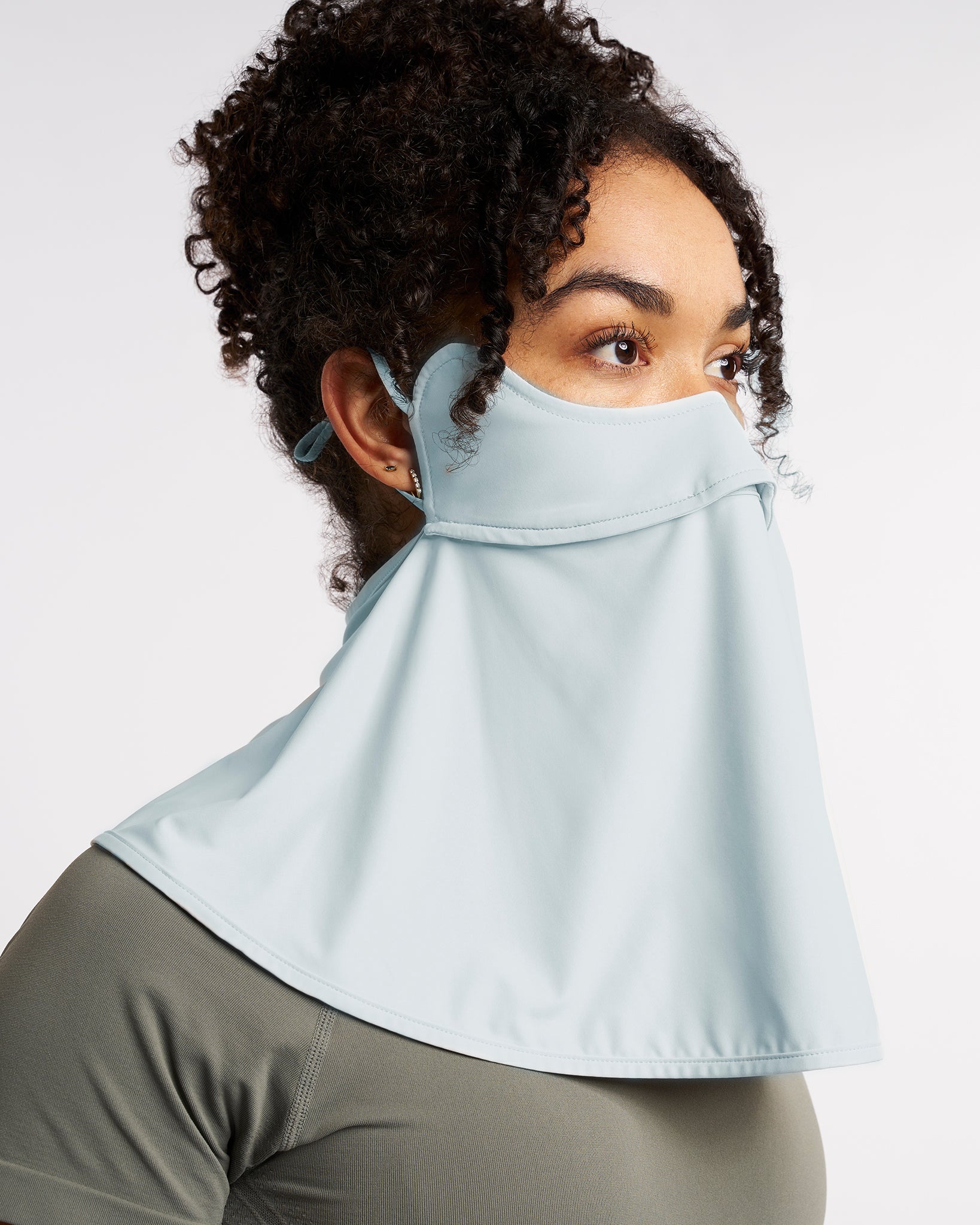 Woman wearing a Light Blue UPF 50+ sun protection face mask with full neck coverage, adjustable ear loops, and secure back fit.