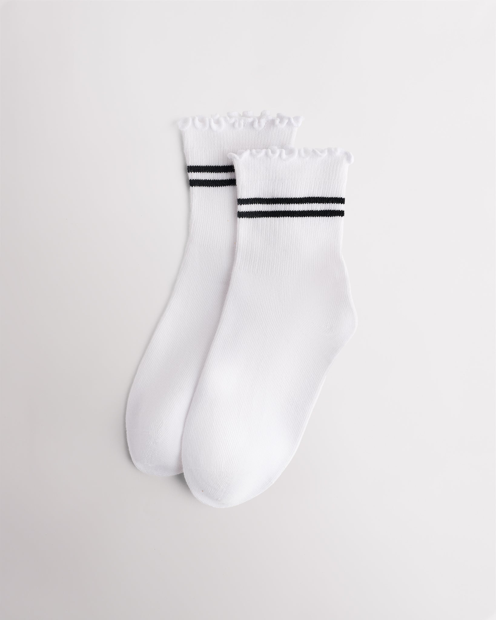 White Stelle Kids Lettuce-Edge Stripes Socks with black stripes, ribbed cuffs, and ruffle trim
