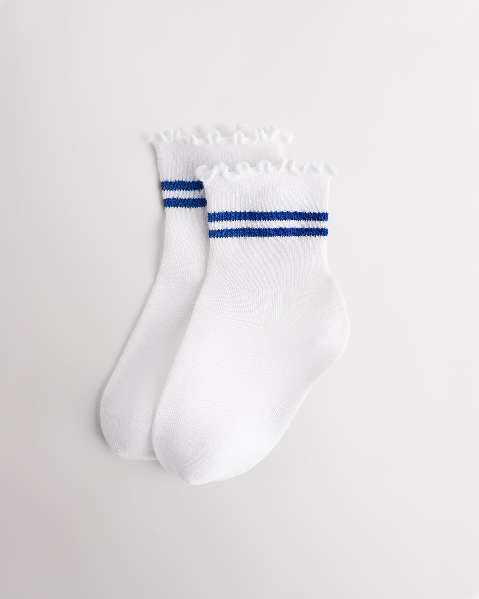 White kids socks with blue sporty stripes, ribbed cuffs, and lettuce-edge ruffle trim
