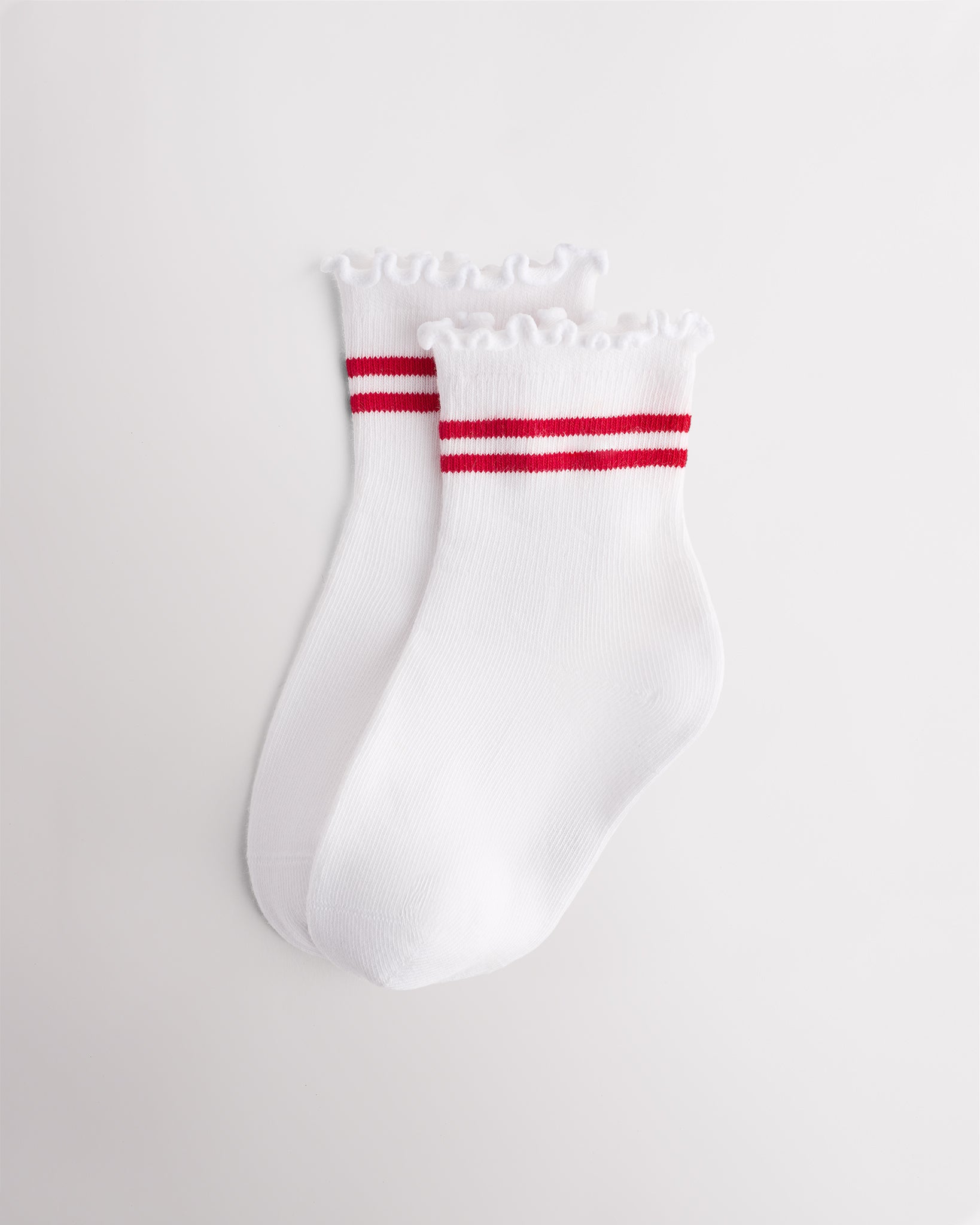 White kids socks with red sporty stripes, ribbed cuffs, and lettuce-edge ruffle trim