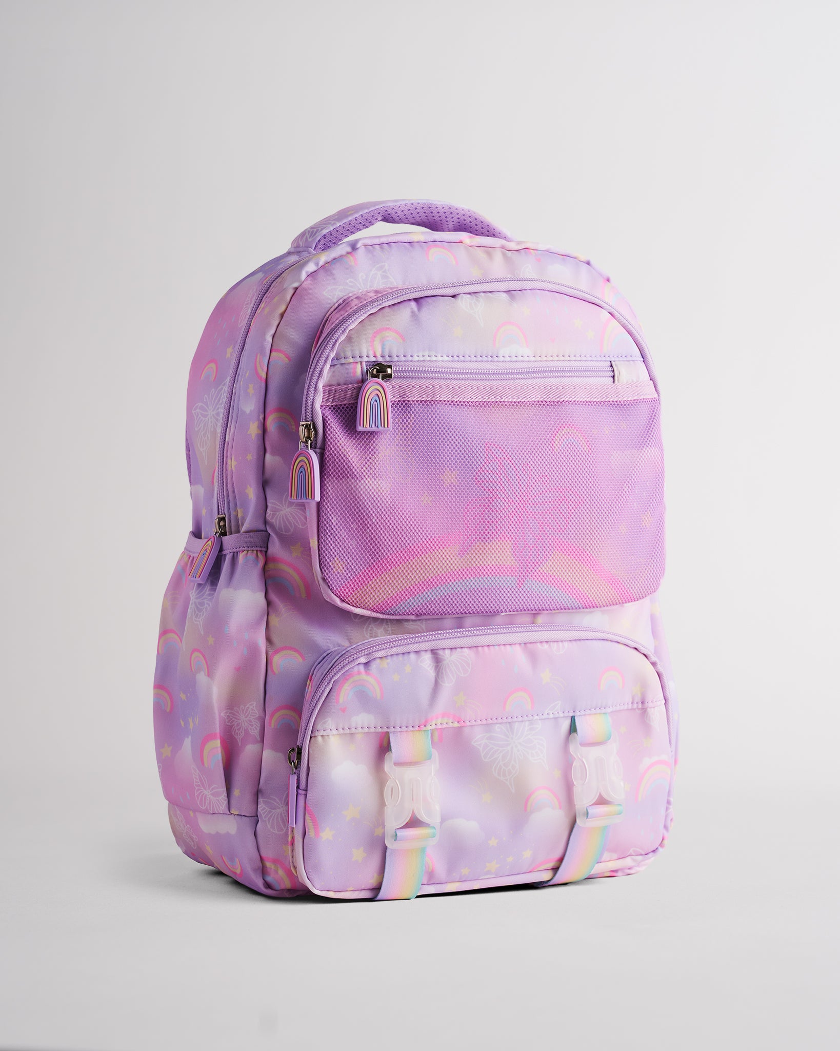 Lavender Stelle kids backpack with rainbow print, mesh front pocket, buckle straps, and multiple zipper pockets for school and travel.