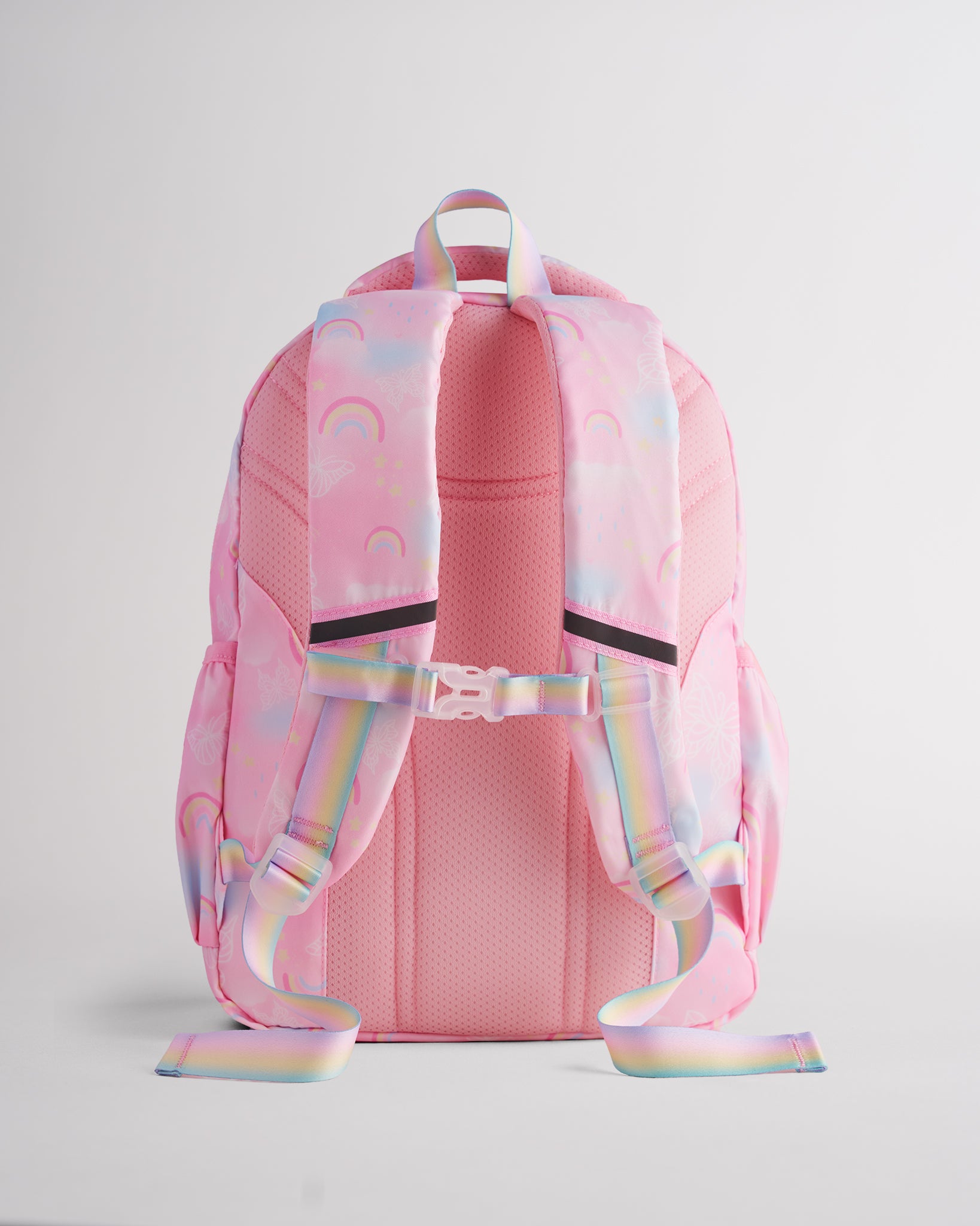 Back view of pink Stelle kids backpack with padded shoulder straps, buckle chest strap, mesh back panel, and rainbow handles.