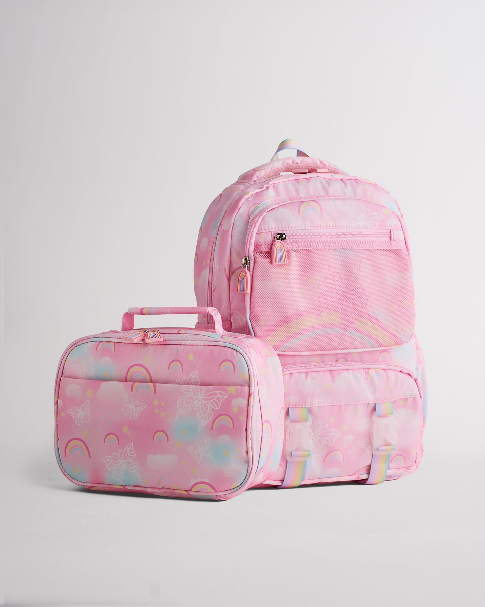 Pink Stelle kids backpack with matching lunch bag, rainbow print, front mesh pocket, and zipper compartments.