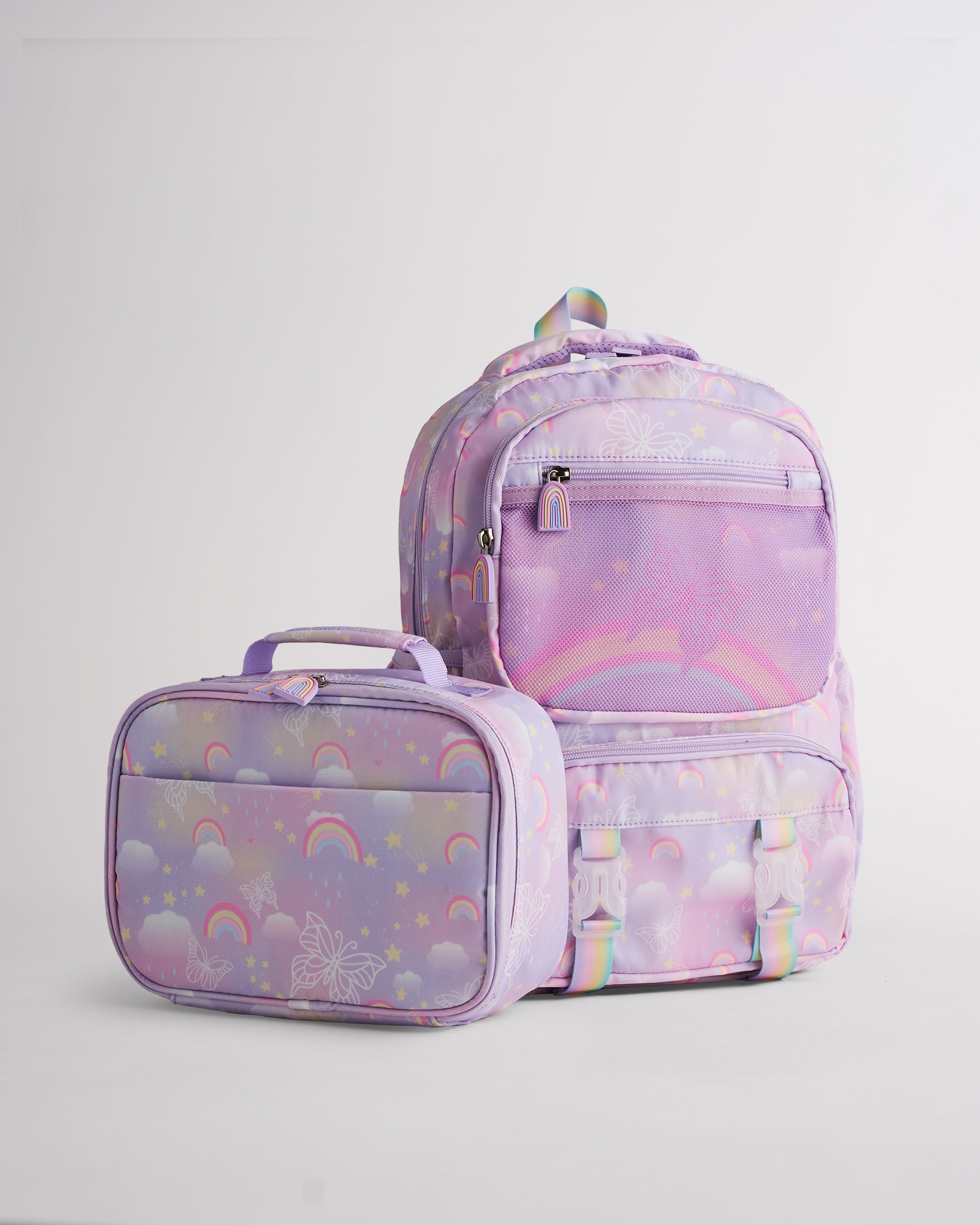 Lavender Stelle kids backpack with matching lunch bag, rainbow print, front mesh pocket, and zipper compartments.