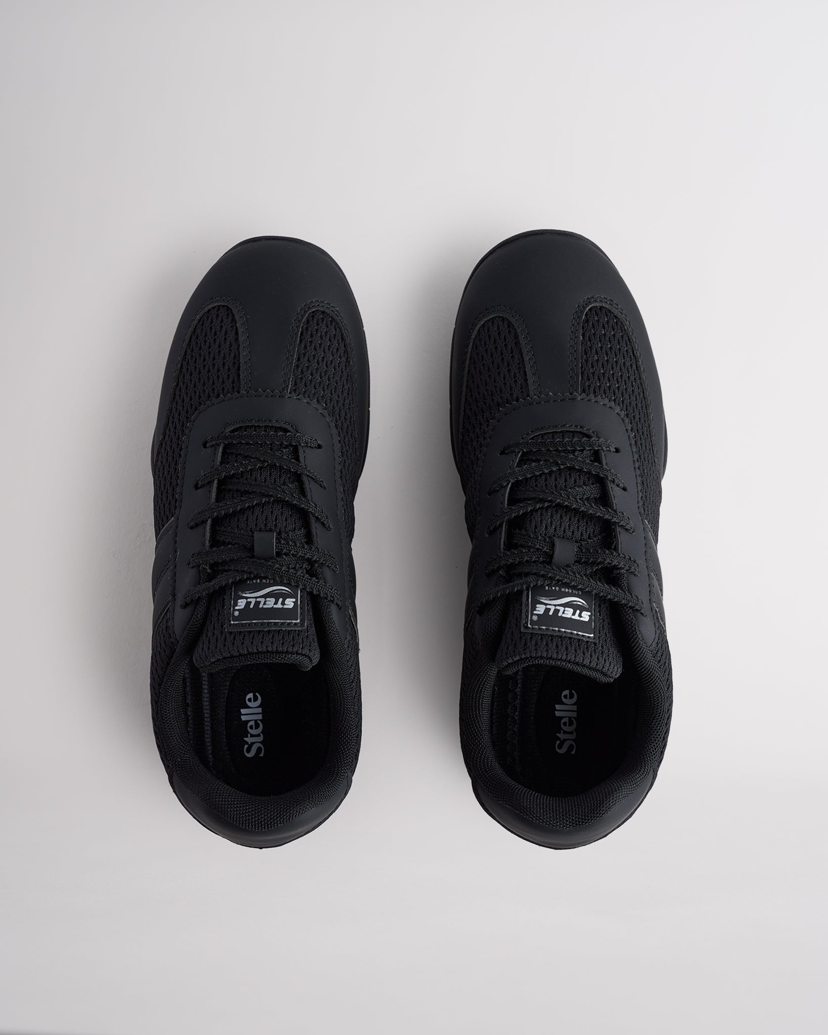 Black Studio air mesh cheer shoes with lace-up closure.