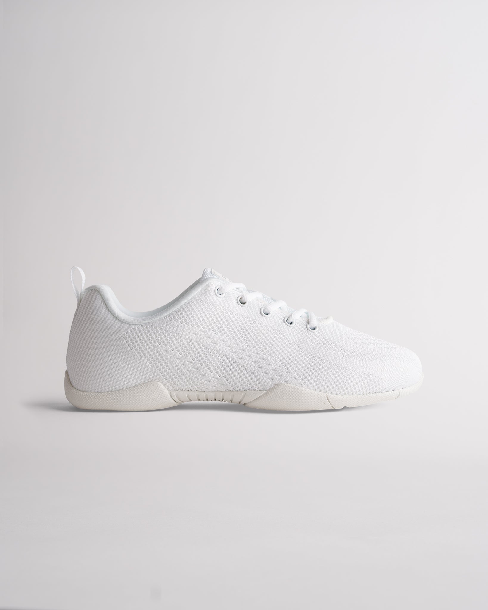 White cheer shoes with knit upper, lace-up design and flexible sole for training and performance