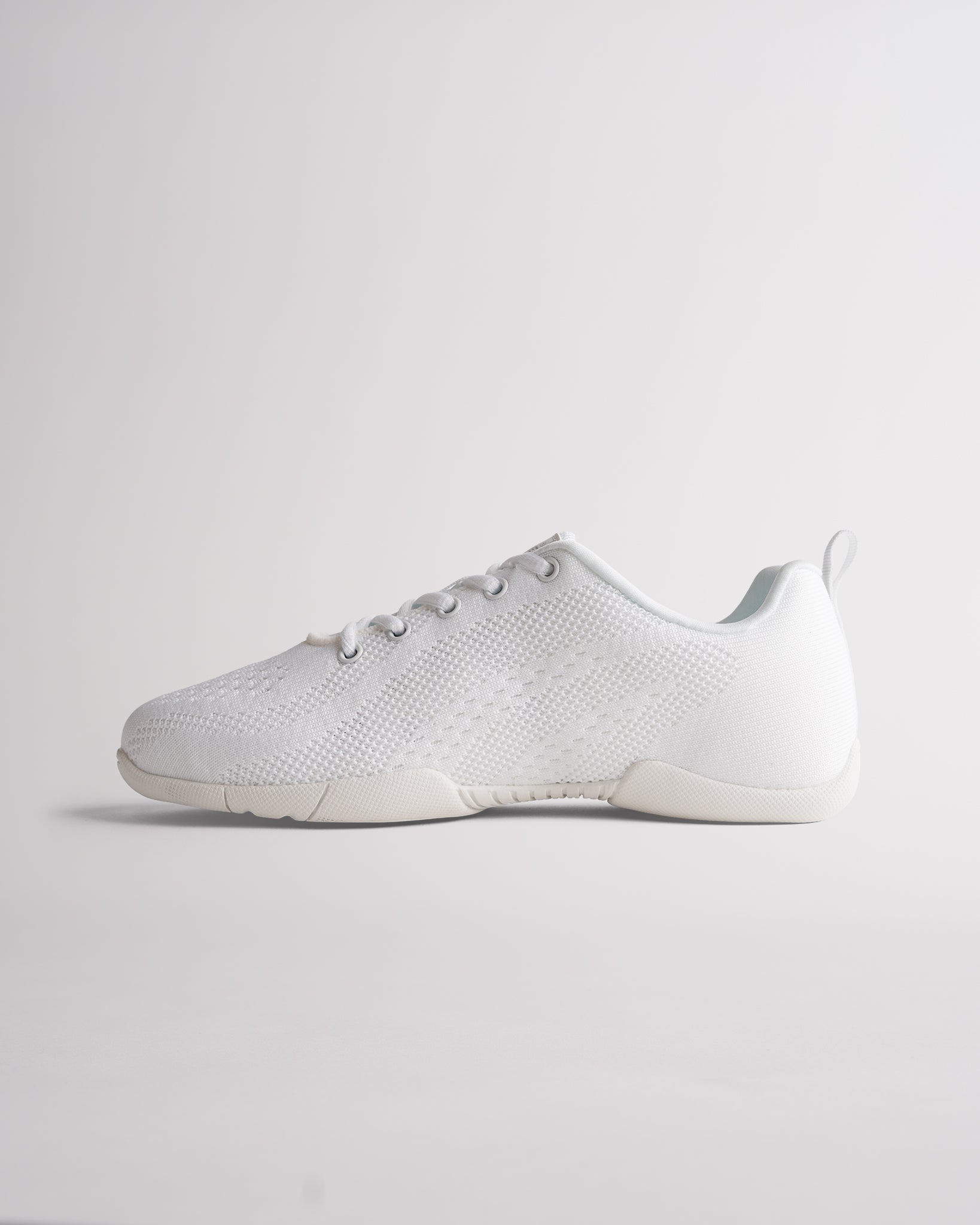 Lightweight white cheer shoes featuring breathable knit material and supportive athletic design