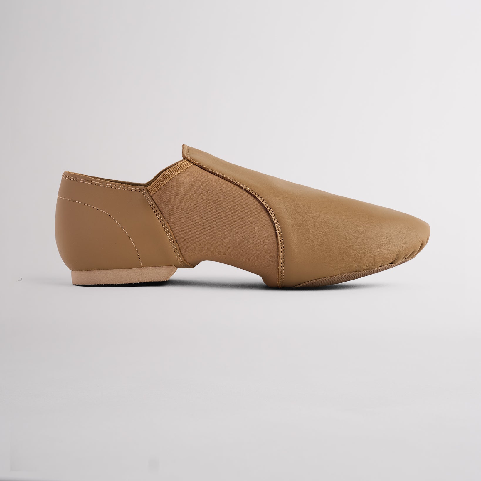 Latte slip-on jazz shoe with split-sole design, stretchy neoprene arch, and sleek second-skin fit for jazz and dance.