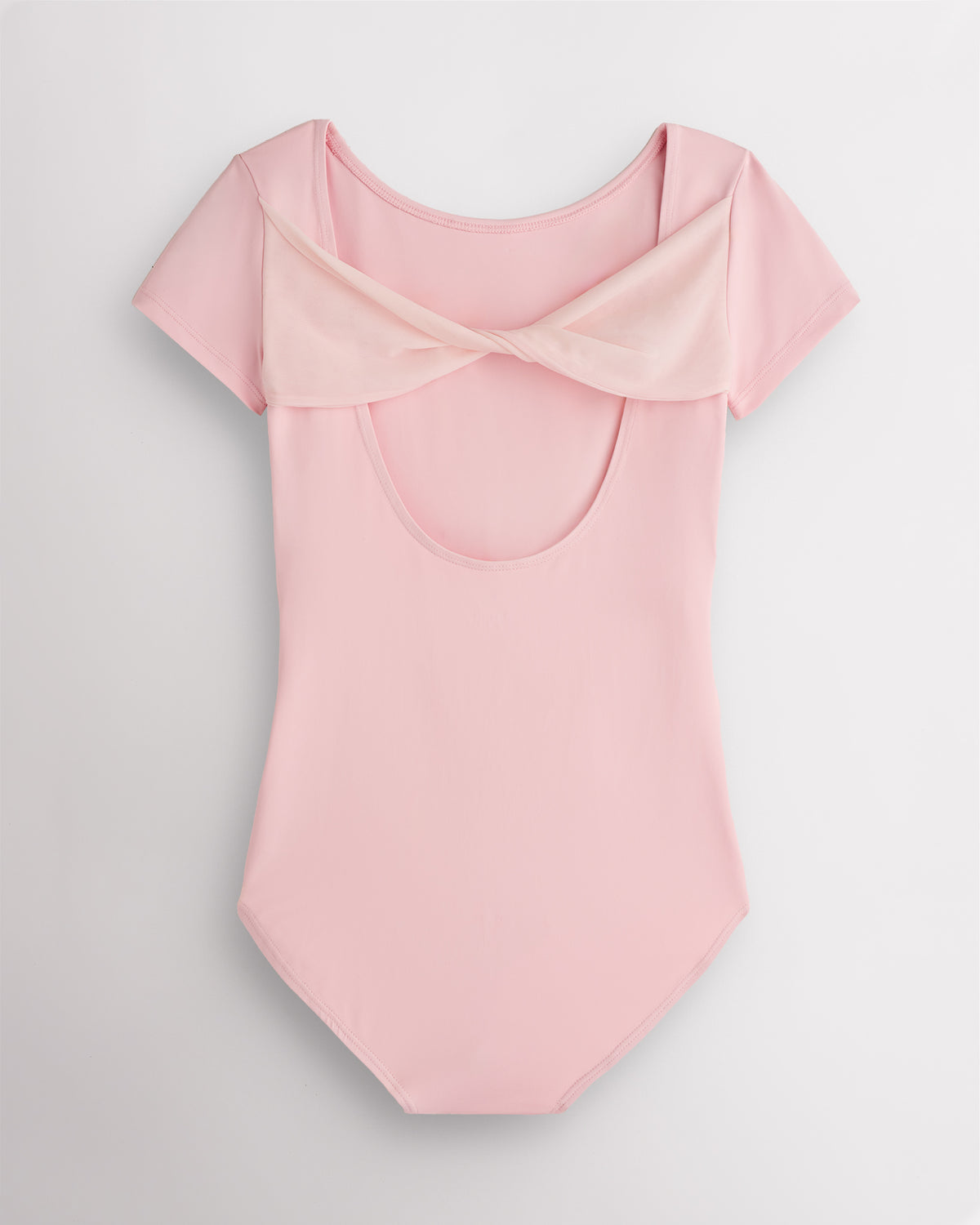 Back view of Ballet Pink women’s dance leotard with twisted mesh detail and open-back silhouette.