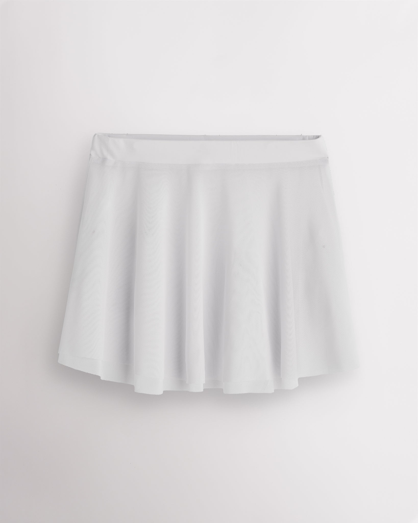 White Stelle womens mesh dance skirt with elastic pull-on waistband, flared silhouette, and slightly longer back hem.