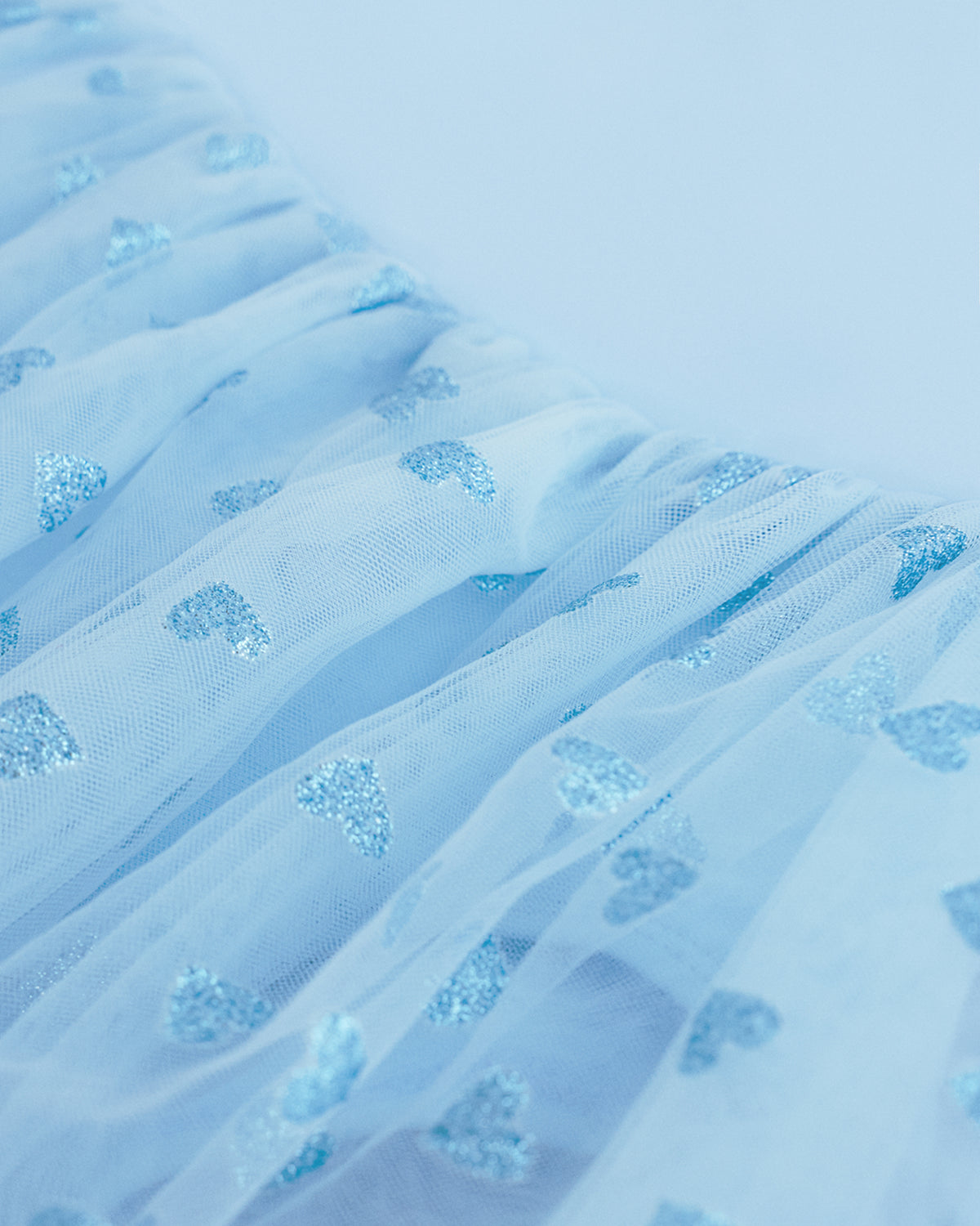 Close-up of Blue mesh skirt showing soft layered fabric and subtle shimmer details.