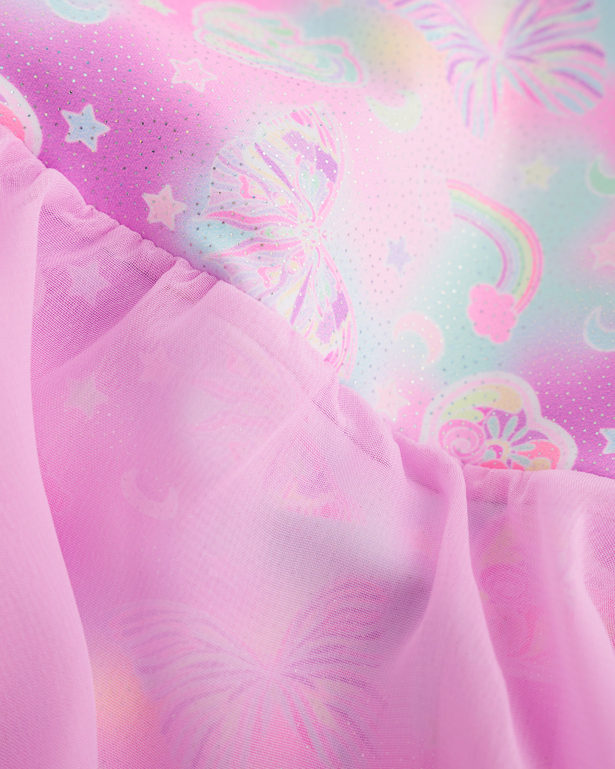 Close-up of Bow Dreams ballet dress showing the pink shimmering print and lightweight skirt fabric.