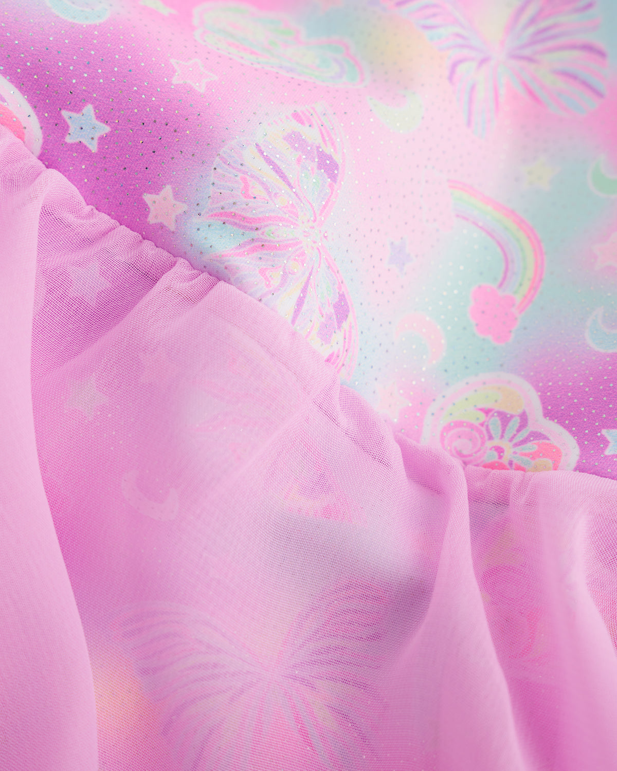 Close-up of Bow Dreams ballet dress showing the pink shimmering print and lightweight skirt fabric.