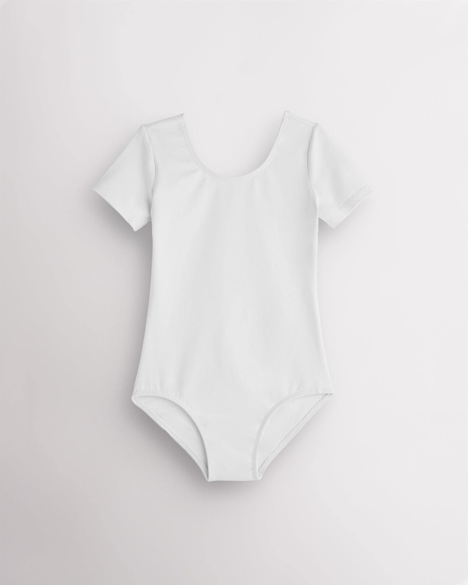 White leotard for girls with short sleeves, scoop neckline, and smooth performance fabric for ballet and dance.