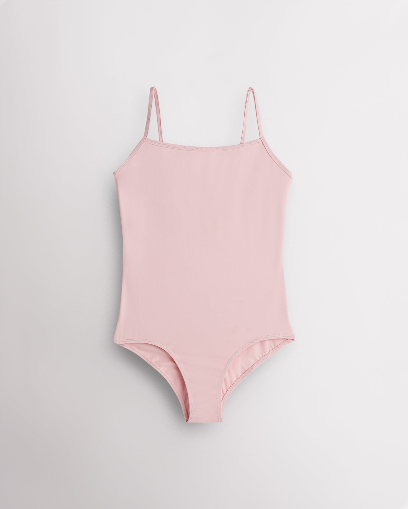 Ballet Pink girls camisole leotard with adjustable spaghetti straps, front lining, and smooth performance fabric.