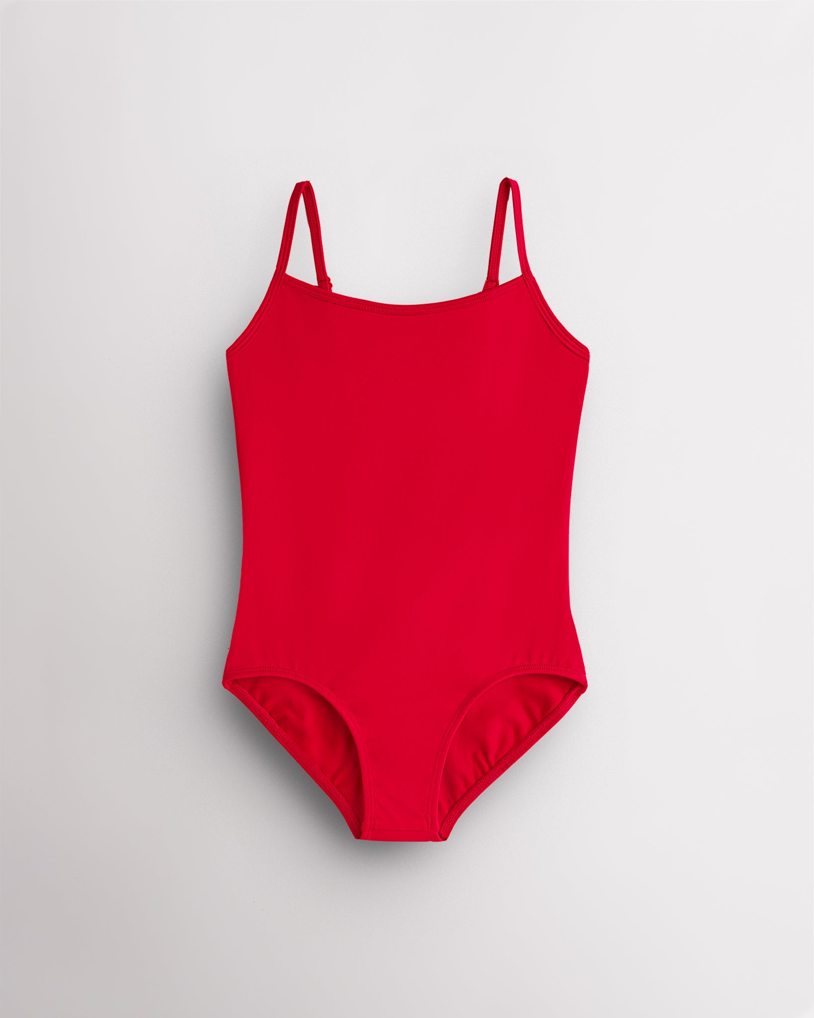 Red girls camisole leotard with adjustable spaghetti straps, front lining, and smooth performance fabric.