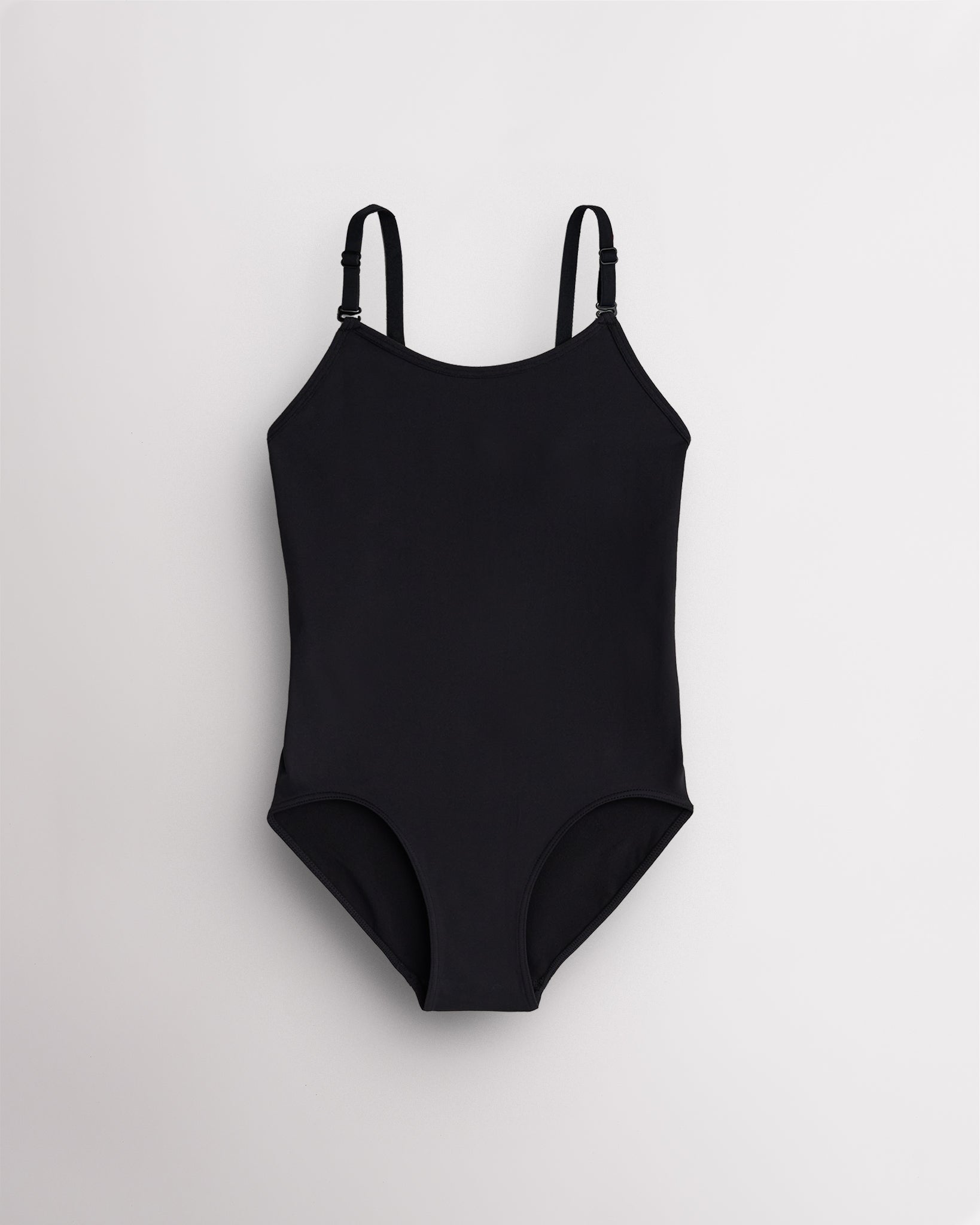 Black seamless camisole girls leotard with scoop neckline, adjustable straps, and smooth ballet base-layer design.