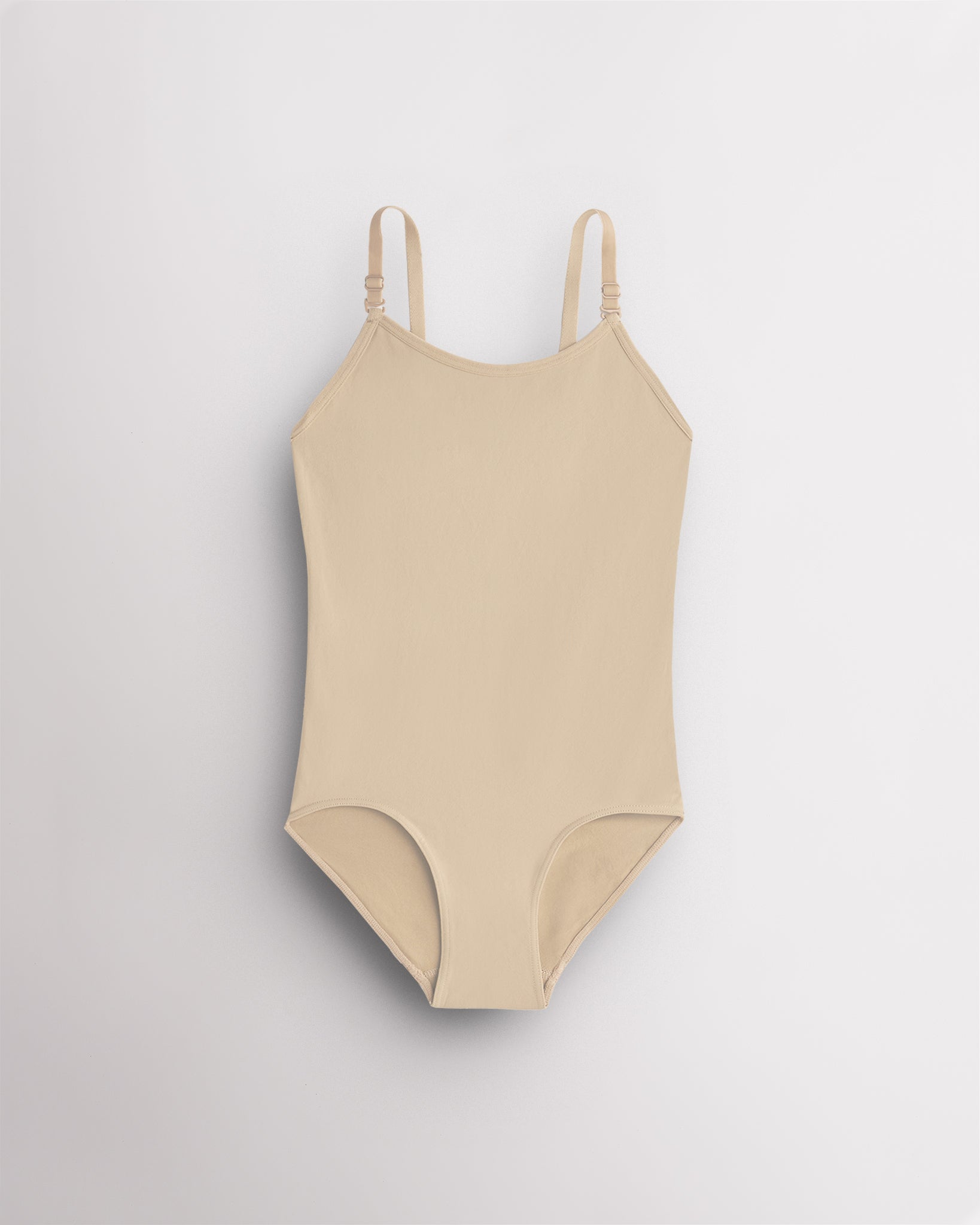 Light Nude seamless camisole girls leotard with scoop neckline, adjustable straps, and smooth ballet base-layer design.