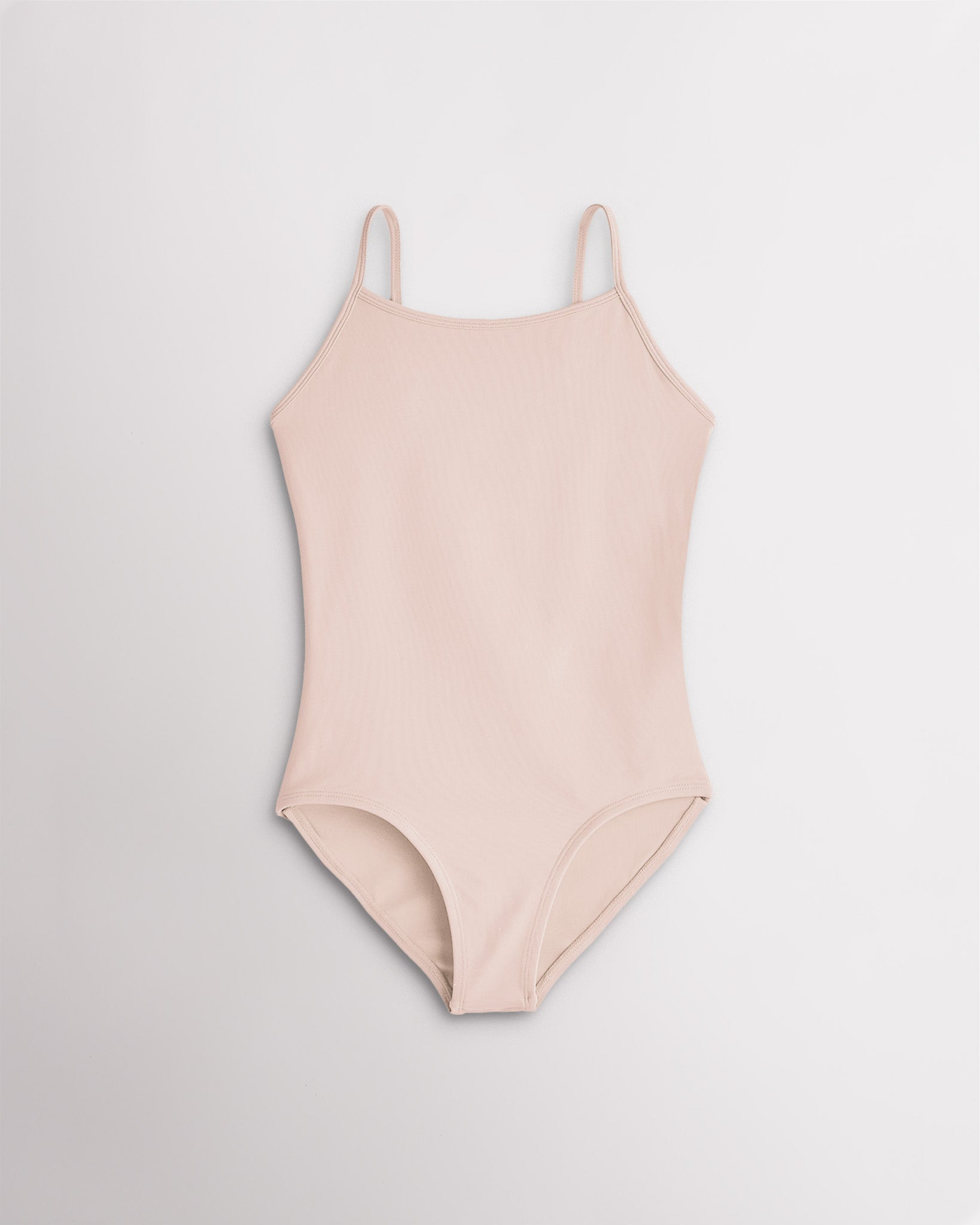 Girls nude camisole leotard with adjustable straps and smooth stretch fabric for ballet and gymnastics.