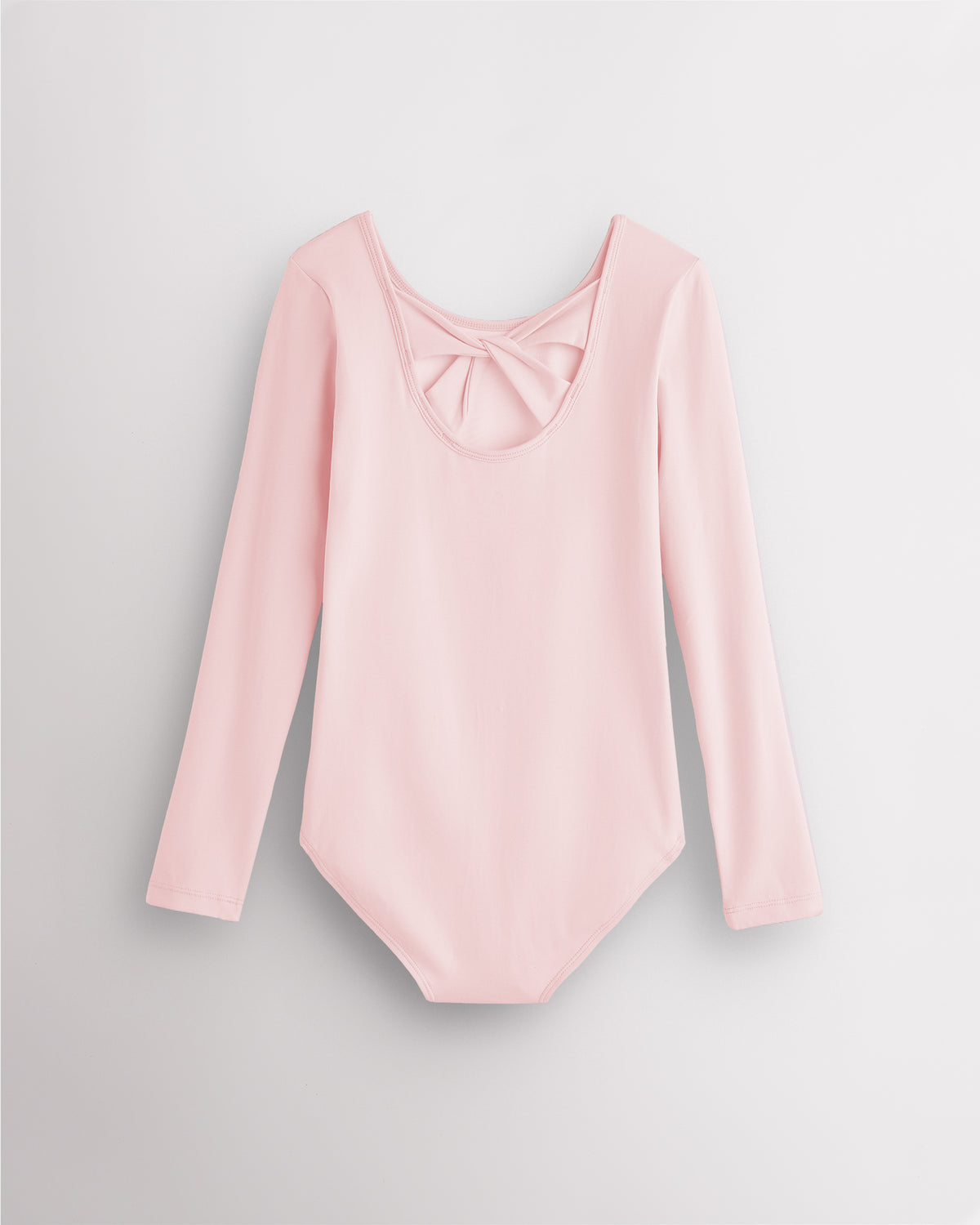 Back view of ballet pink long sleeve leotard for girls with twist-back bow detail and soft cotton fabric.