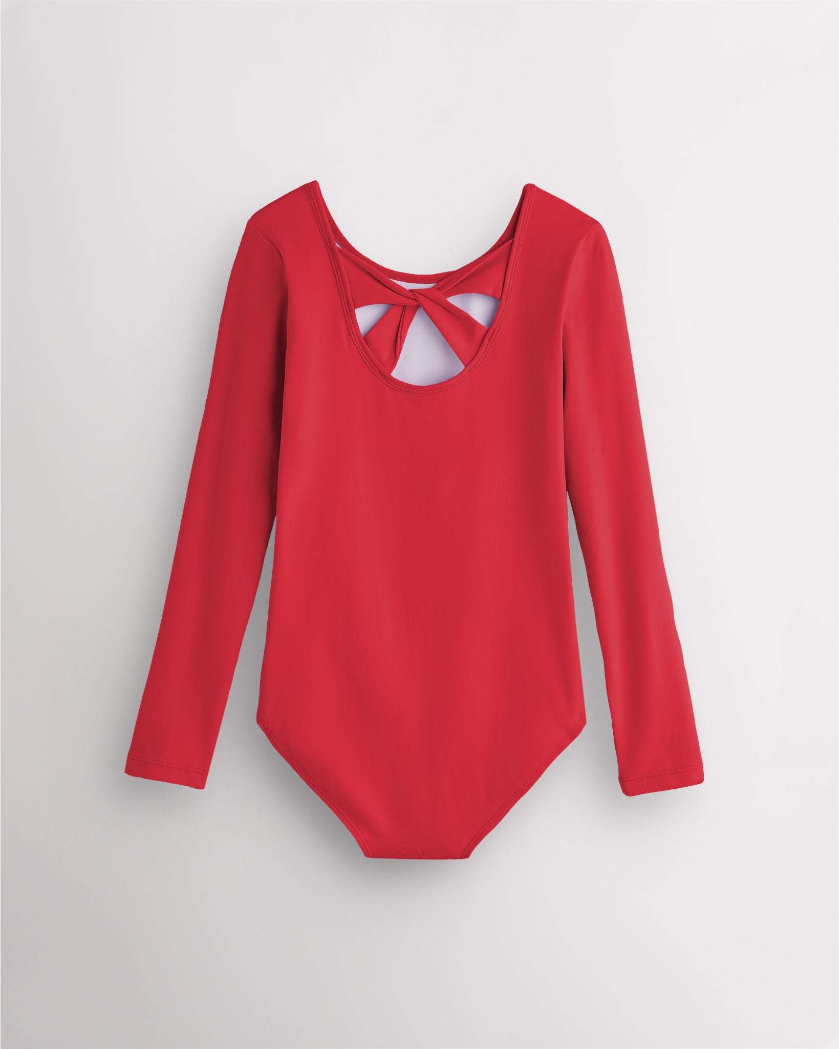 Back view of red long sleeve leotard for girls with twist-back bow detail and soft cotton fabric.