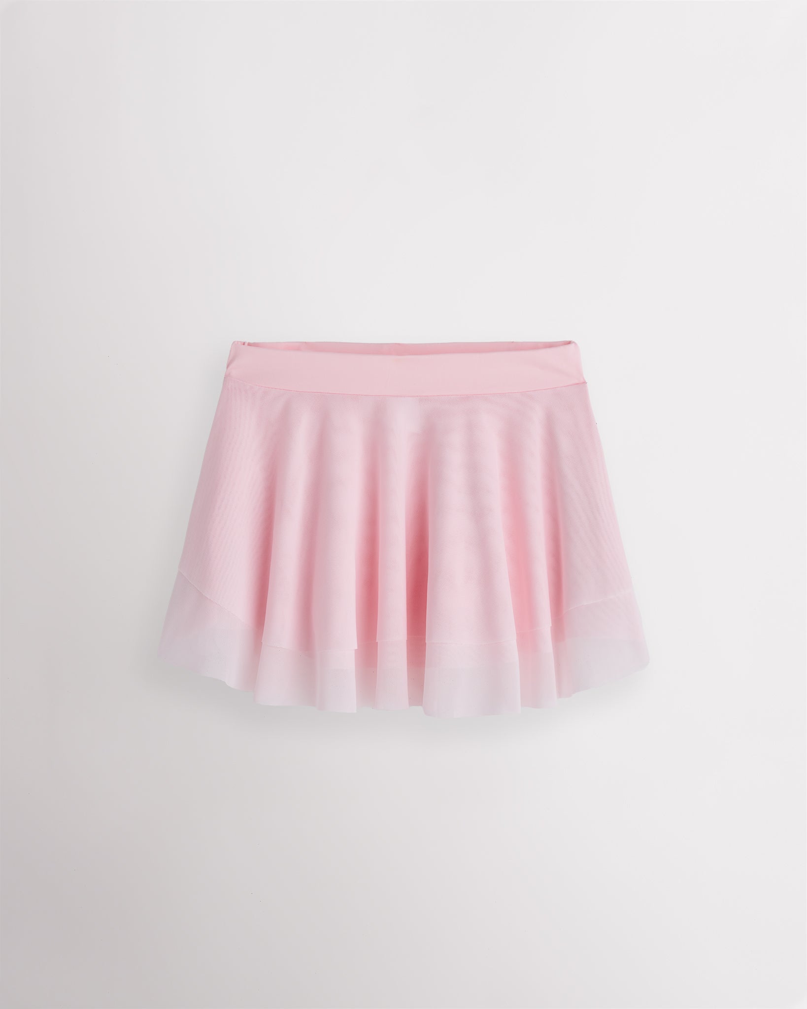 Ballet pink Stelle girls ballet skirt with double-layer mesh, elastic waistband, and a softly curved flared hem.