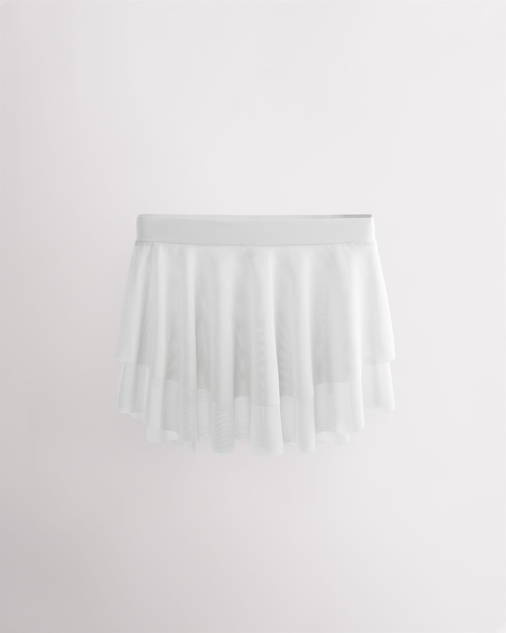 White girls ballet mesh tiered skirt with double-layer mesh, elastic waistband, and curved hem for a flowy silhouette.