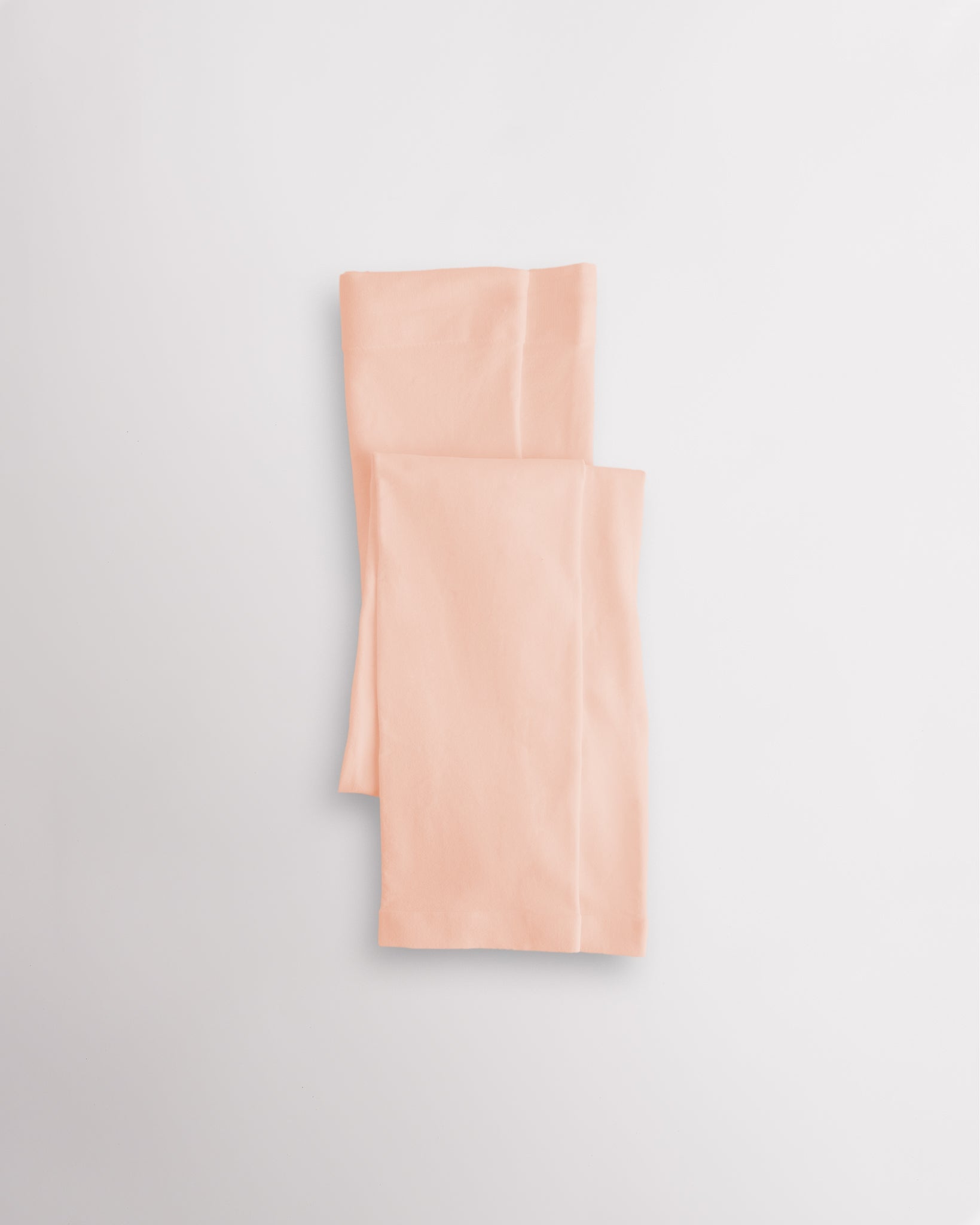 Ballet Pink girls microfiber footless dance tights folded flat with elastic waistband and soft fabric for ballet and dance practice.