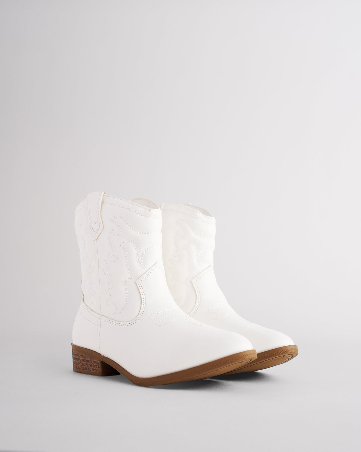 Pair of short white cowgirl boots for kids with western embroidery