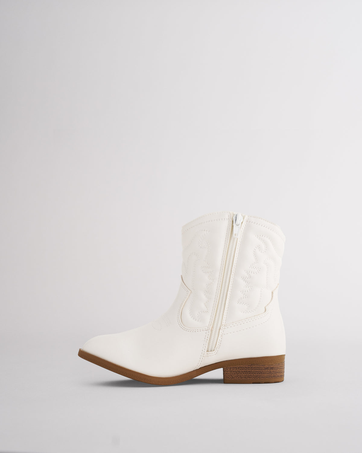 Inner side zipper on a girls white western boot for easy on and off