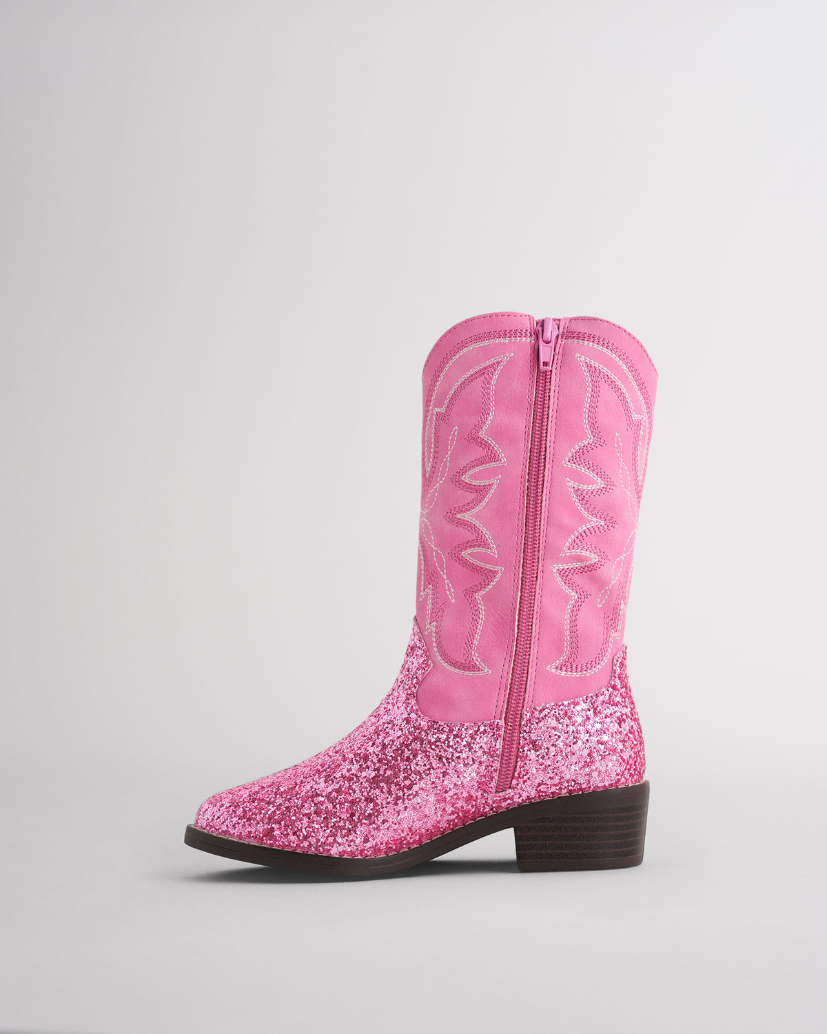 Inside view of a kids pink cowboy boot showing the side zipper for easy on and off