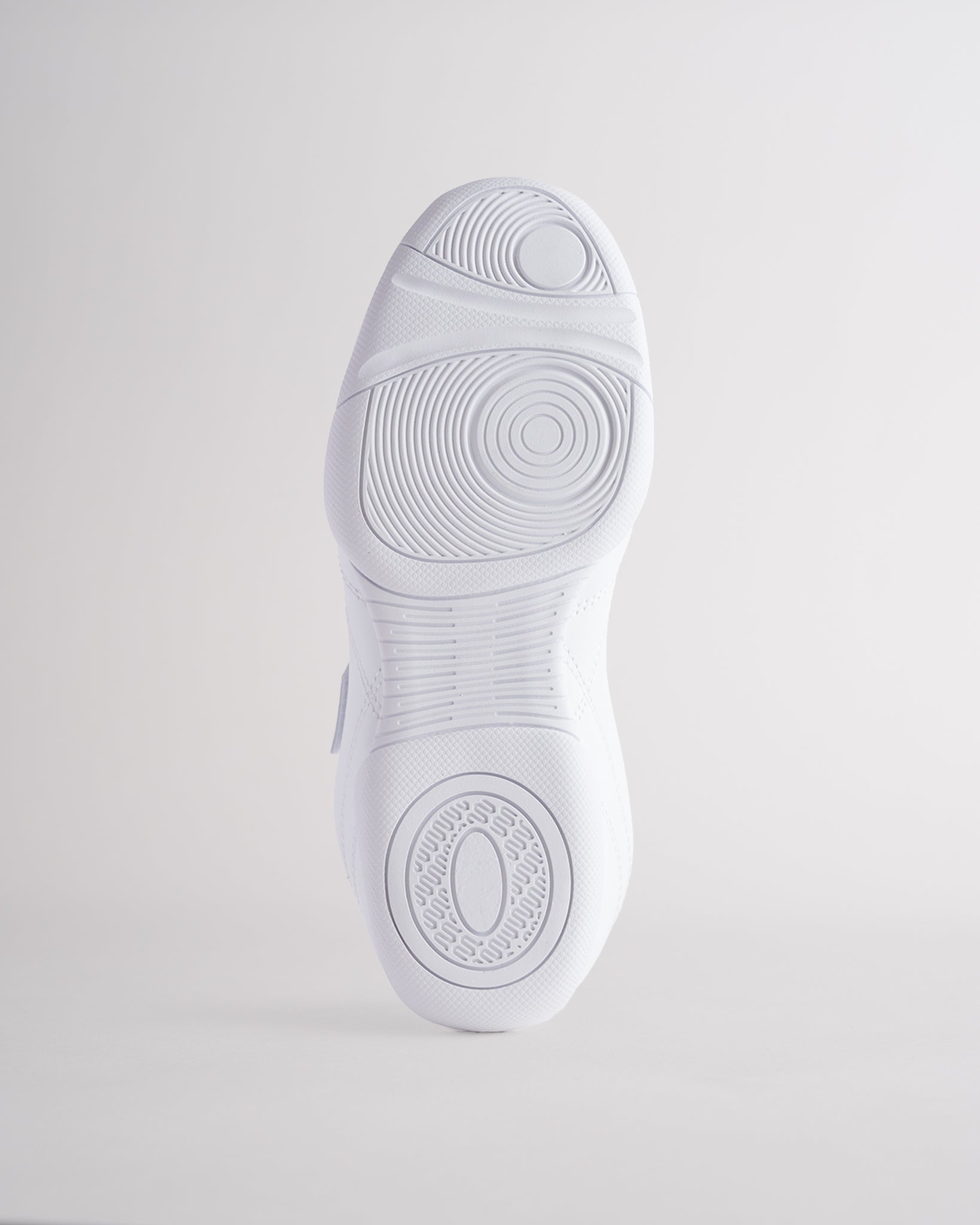 White cheer shoes outsole with textured grip pattern for stability and traction.