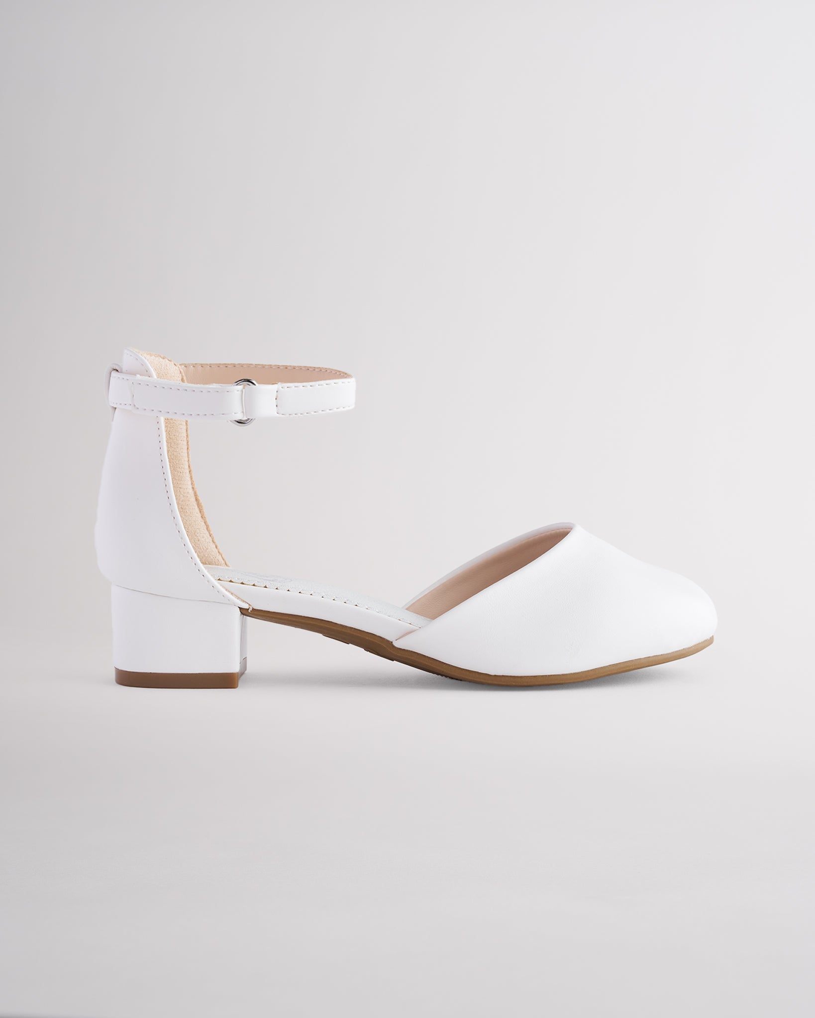 Girls’ white dress shoes with a low block heel and ankle strap.