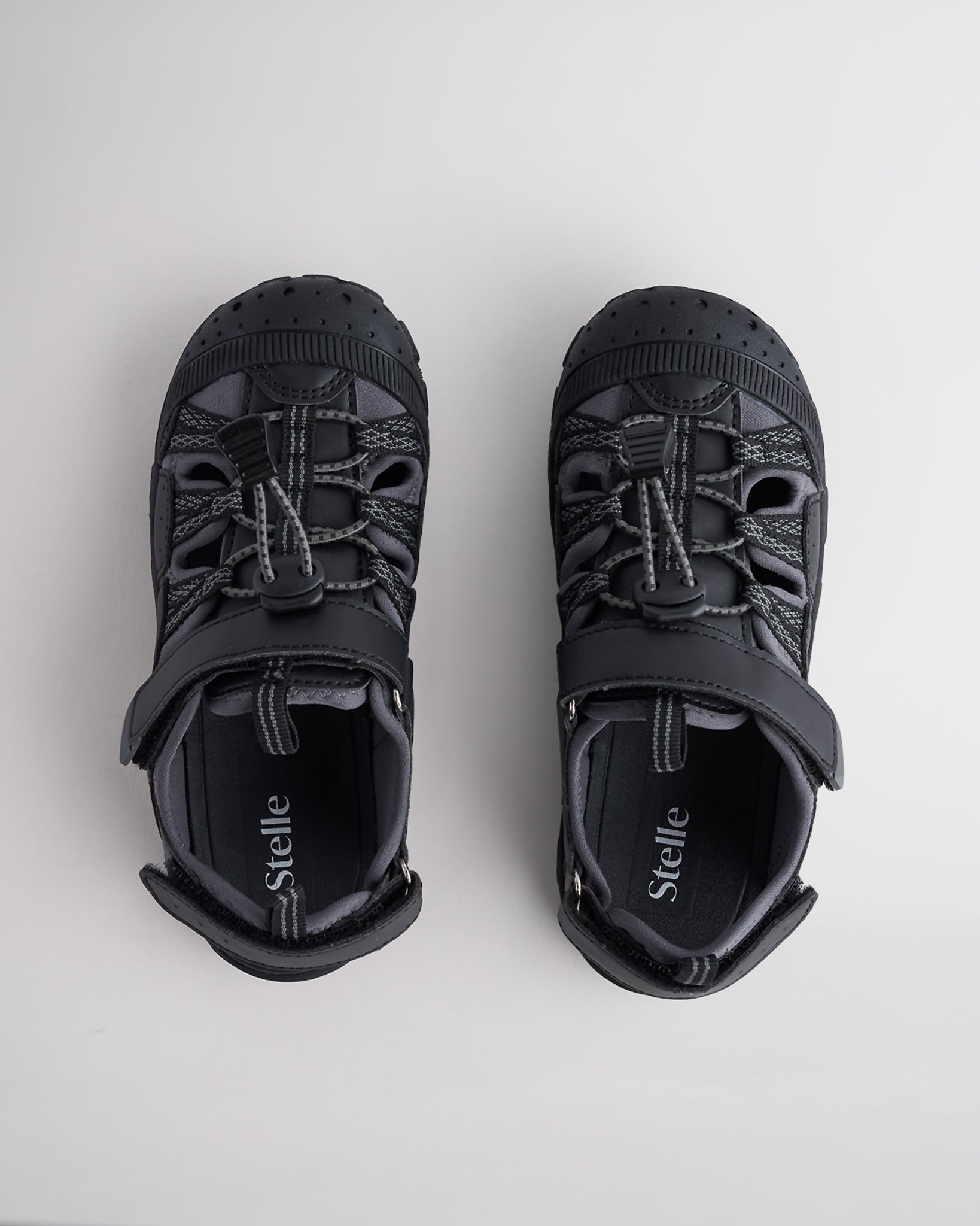 Top view of kids sandals with cord lace system and adjustable hook-and-loop straps for secure fit