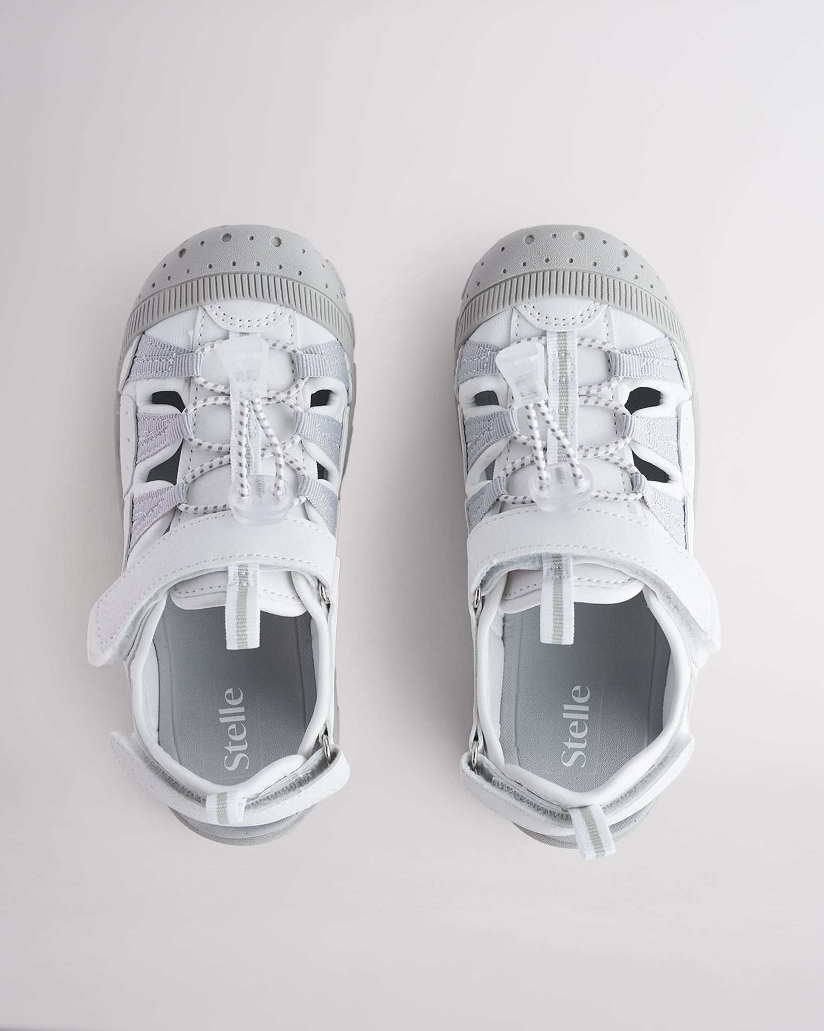 Top view of kids sandals with cord lace system and adjustable hook-and-loop straps for secure fit