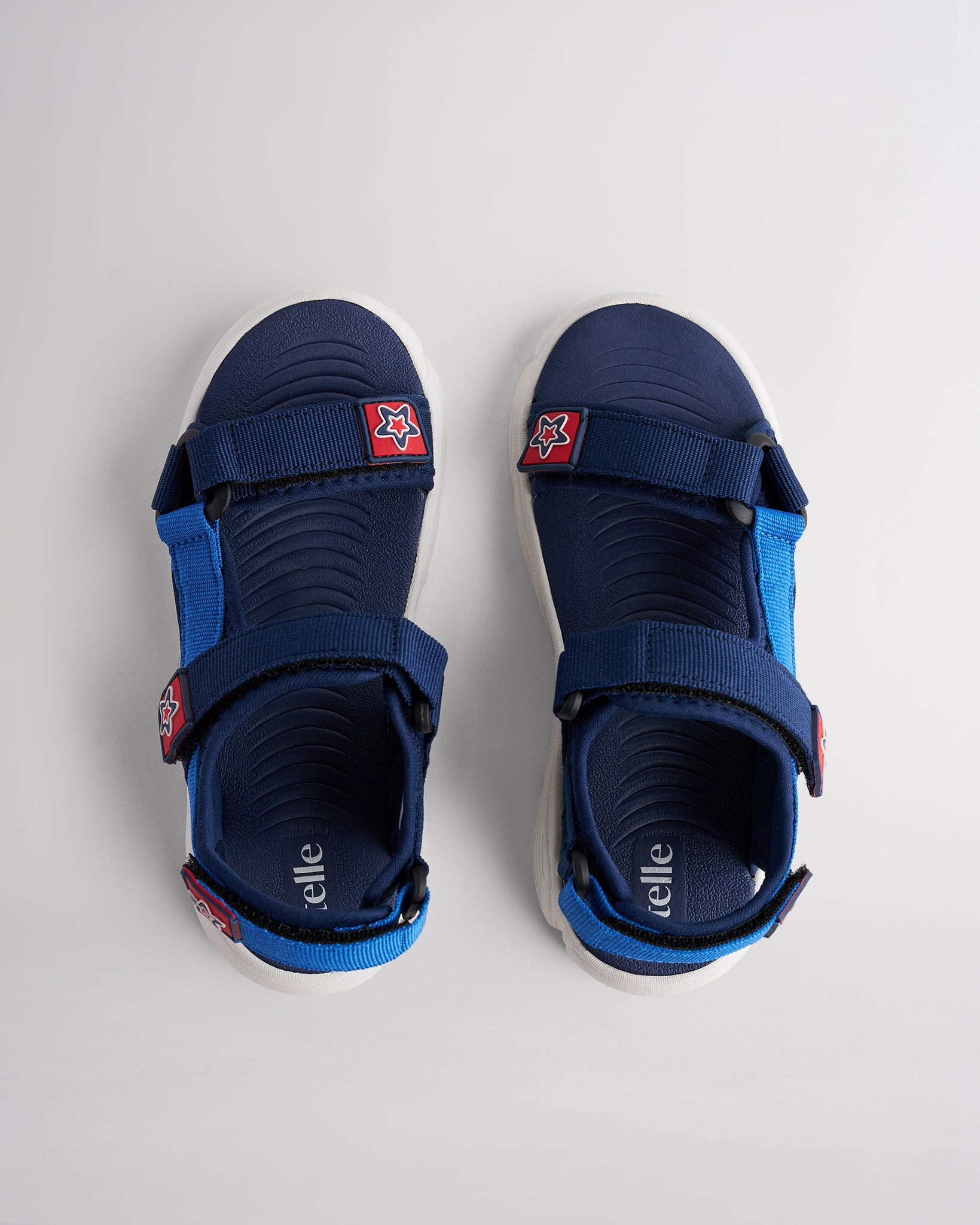 Top view of navy sandals for kids with three adjustable straps and textured footbed