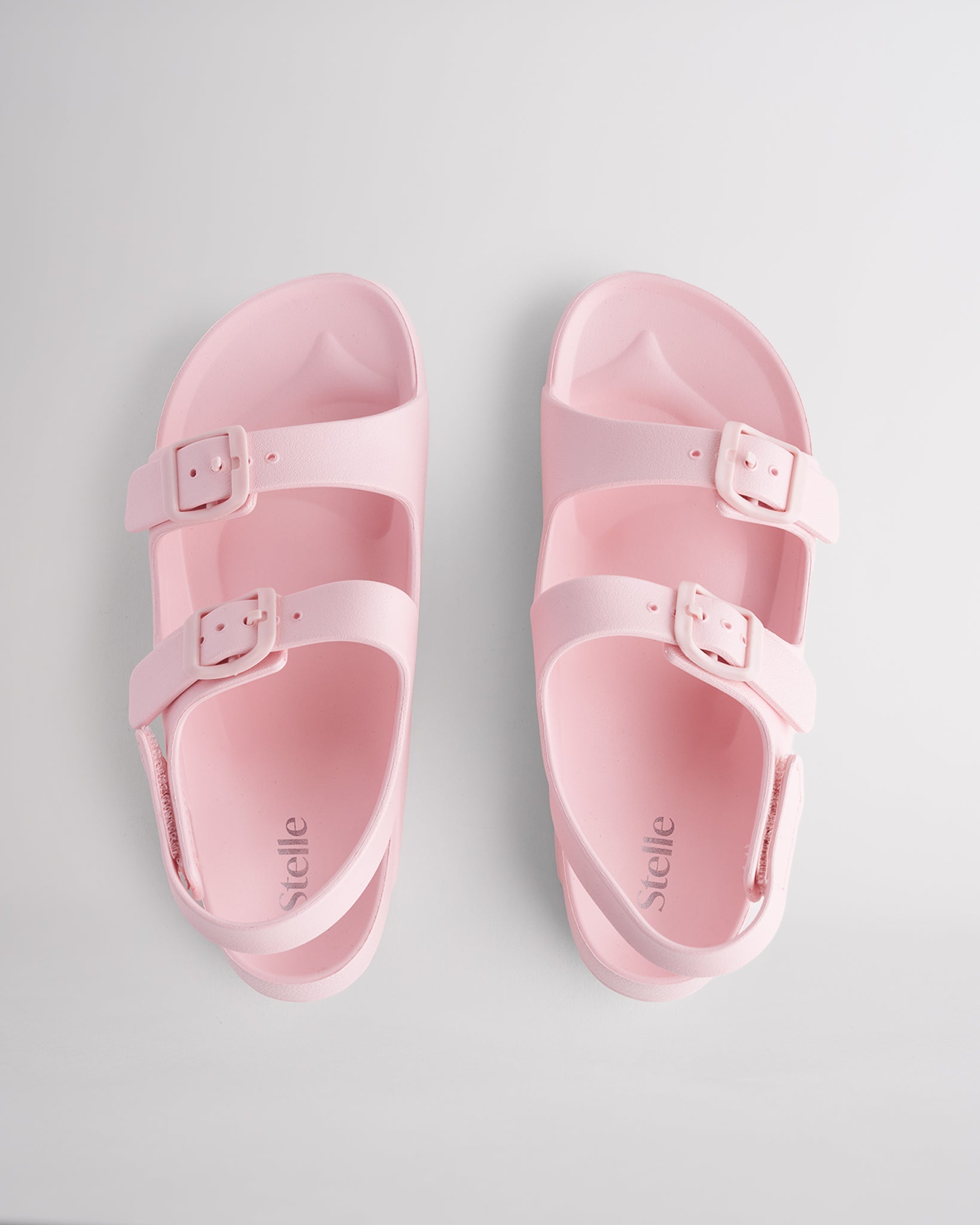 Top view of Pink kids sandals with dual adjustable buckles, contoured footbed, and soft lightweight material