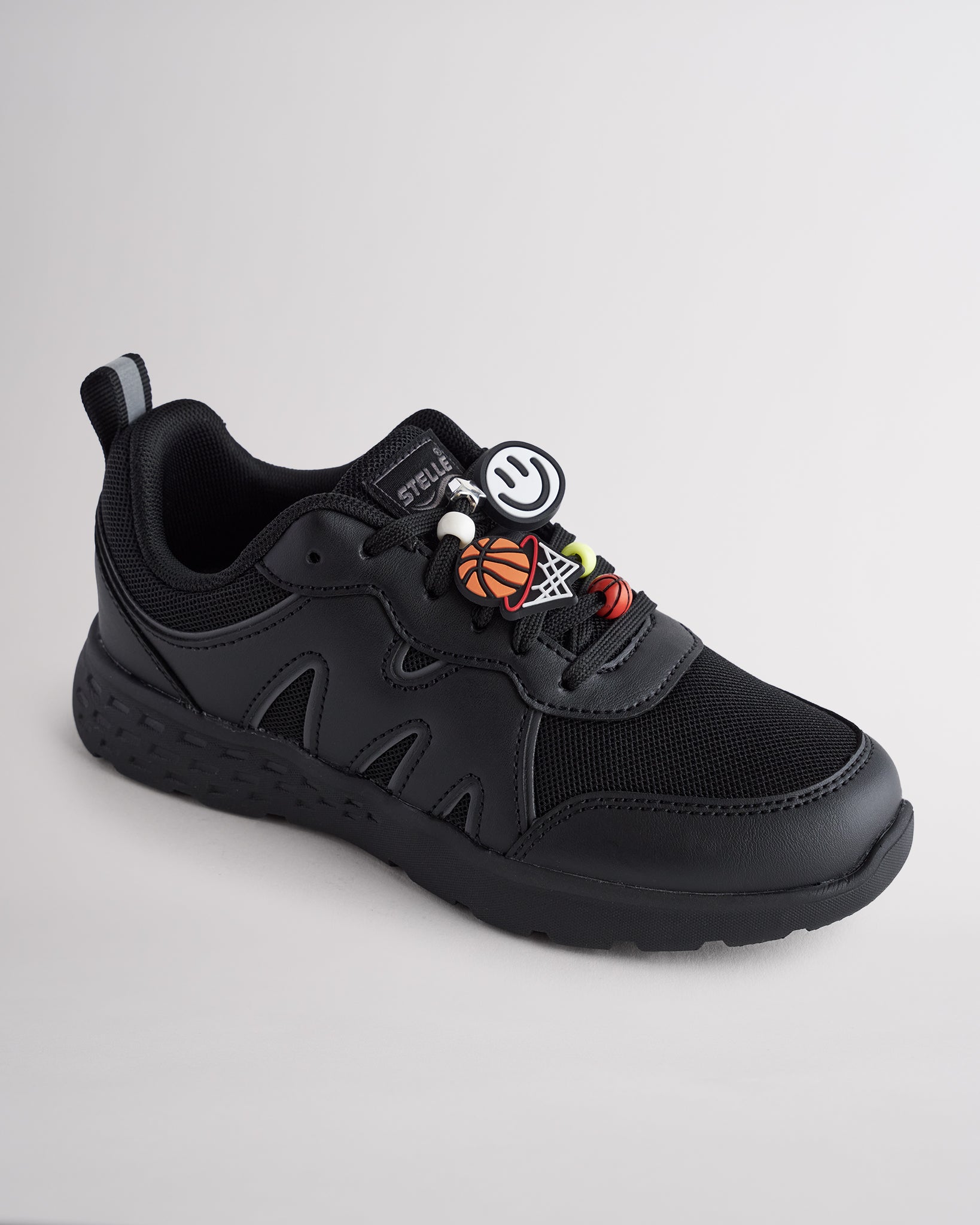 Ninja Black lightweight kids’ sneakers with breathable mesh uppers, a cushioned insole, and a durable outsole.