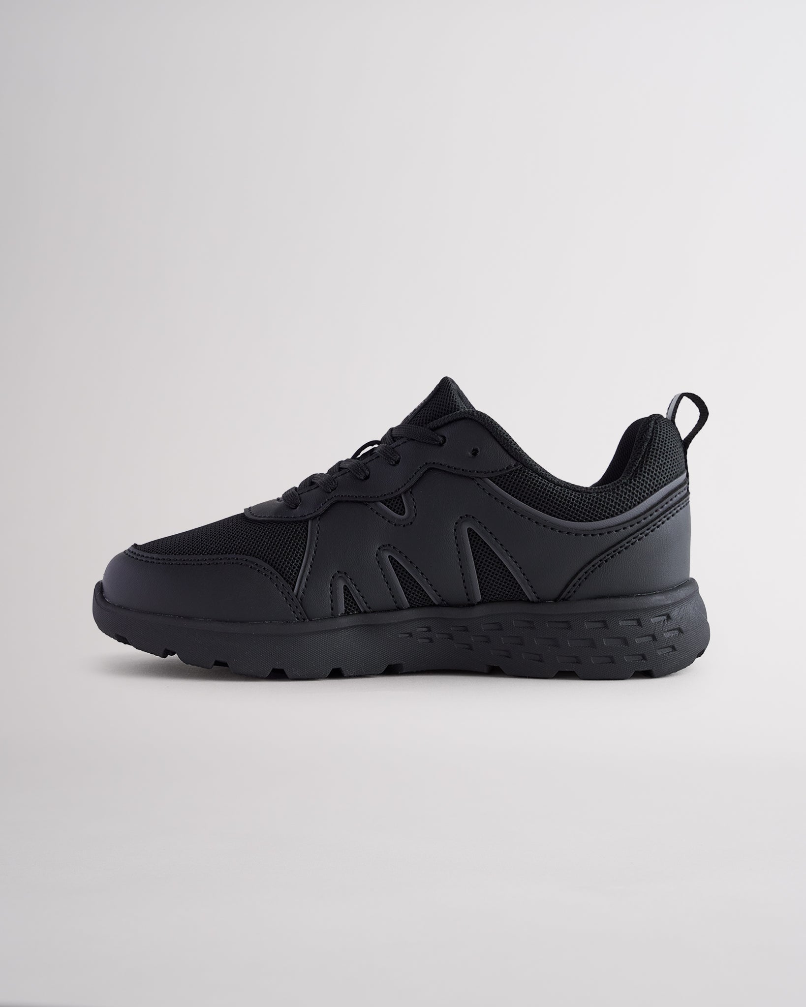 Ninja Black lightweight kids’ sneakers with breathable mesh uppers, a cushioned insole, and a durable outsole.